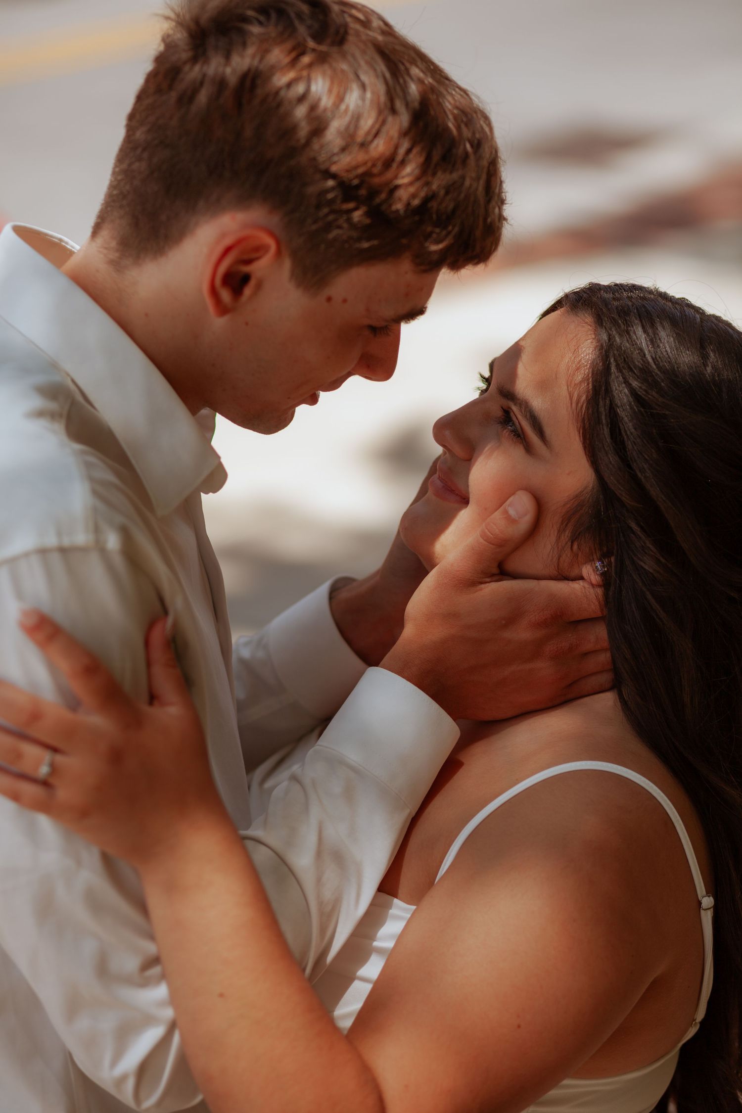 Close-up sequence of tender moments between a couple in white and formal attire.