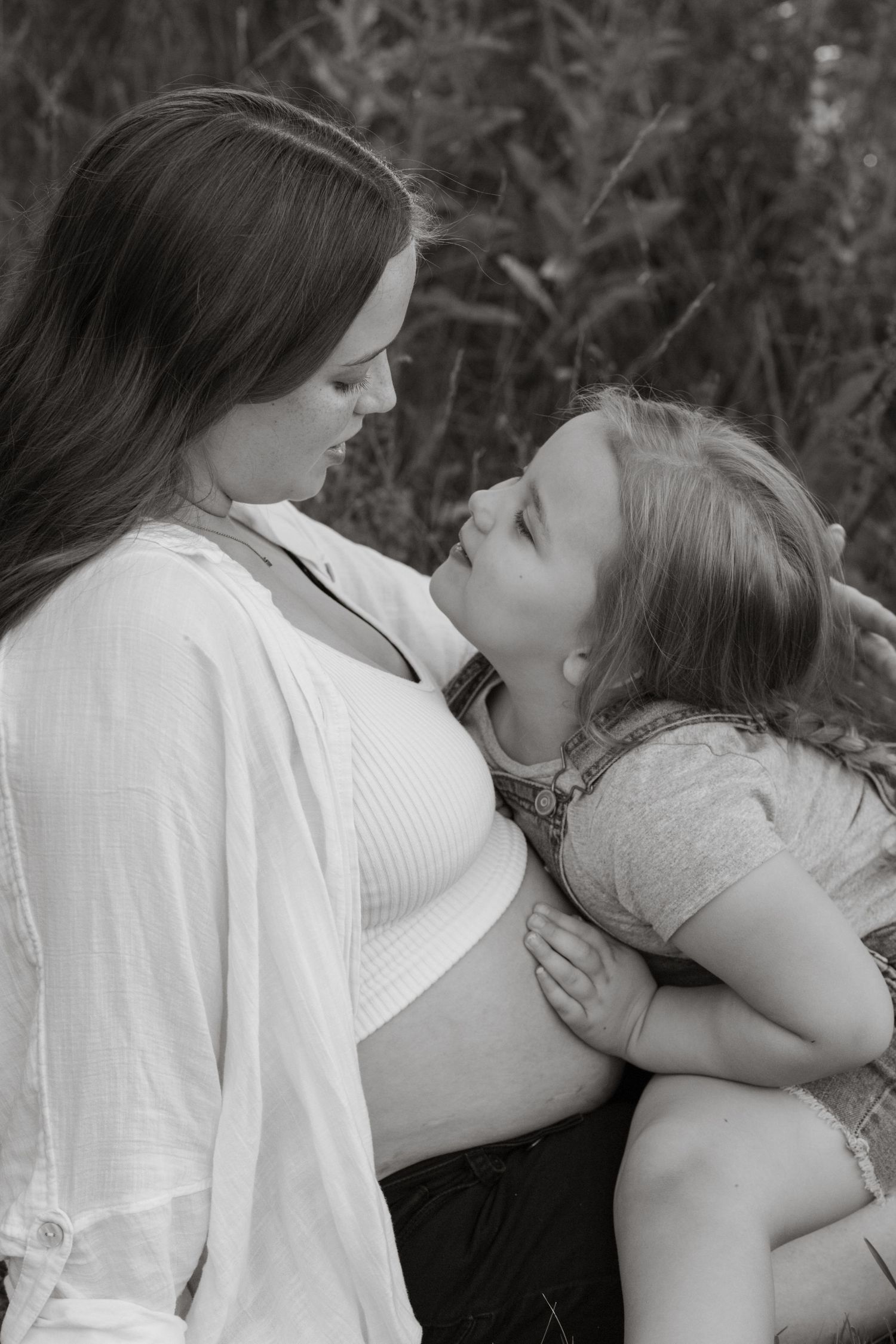 Black and white series showing intimate family moments outdoors.