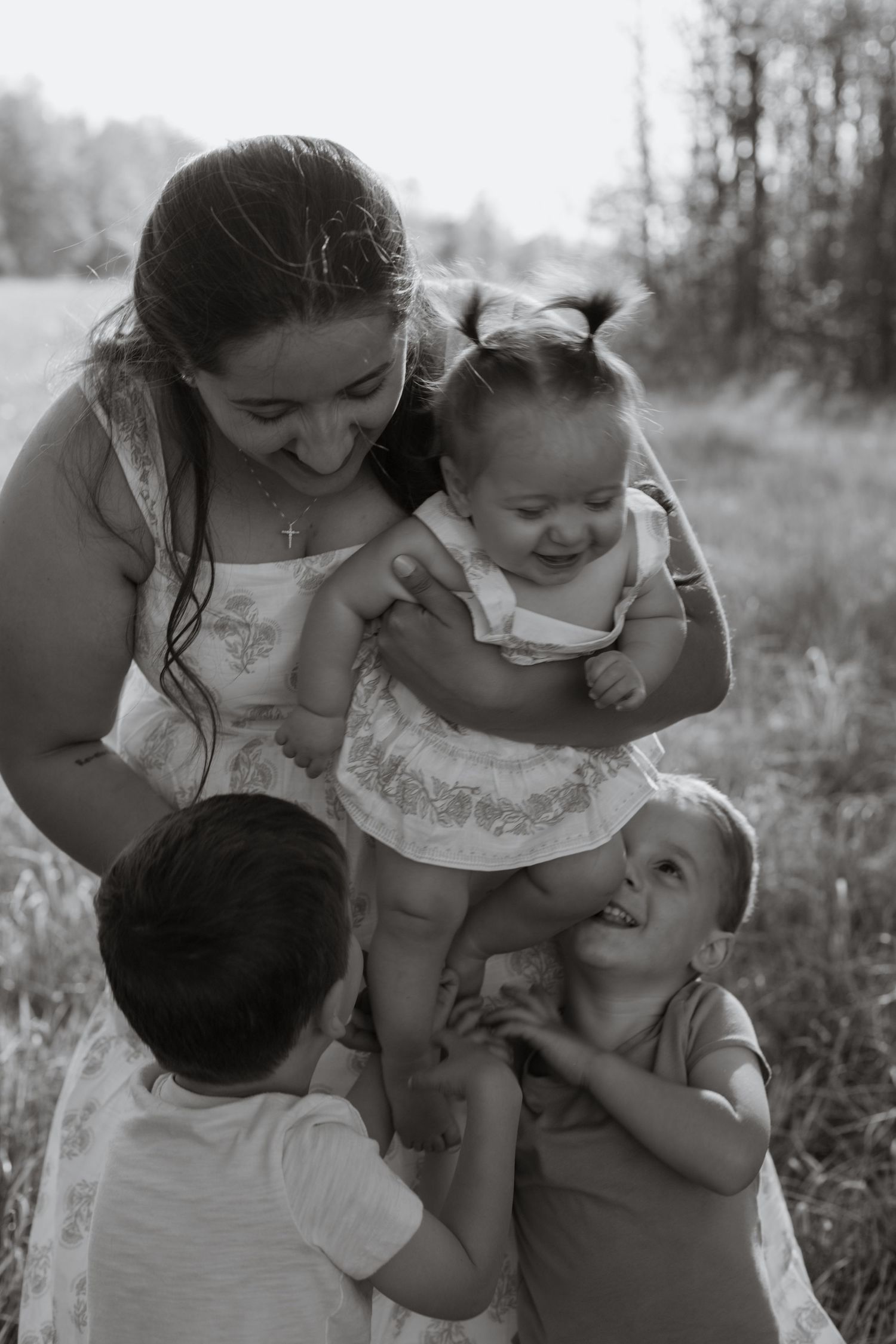 Black and white family photos capturing natural, loving moments between family members.