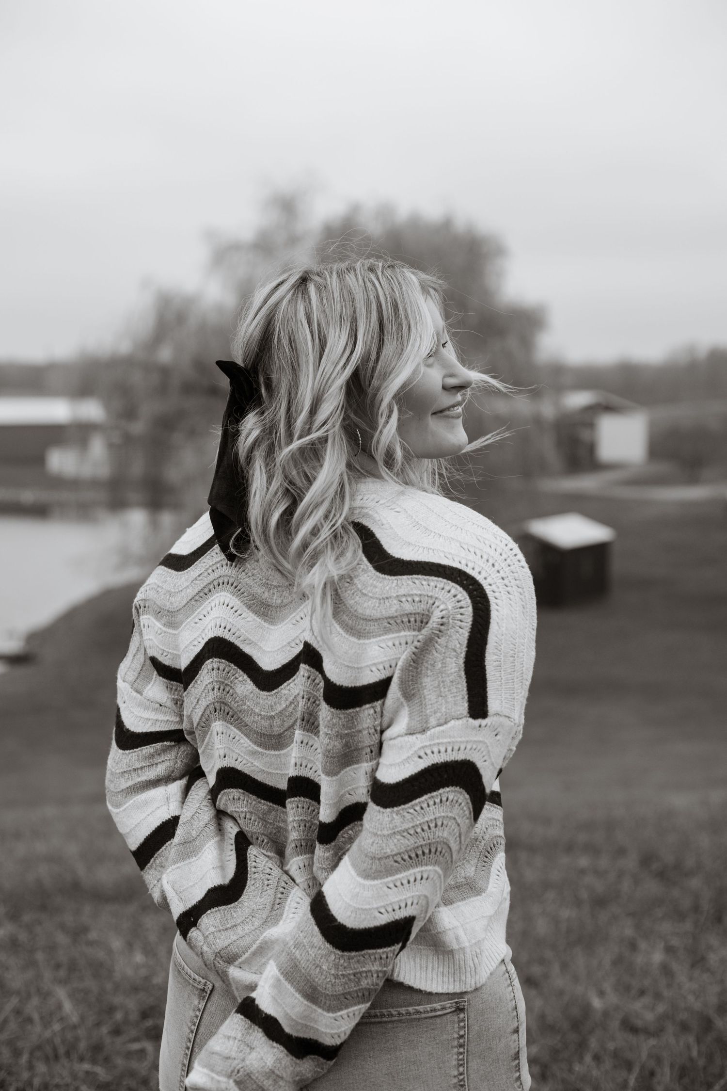 Black and white portrait series showing a wavy striped sweater against an outdoor background.