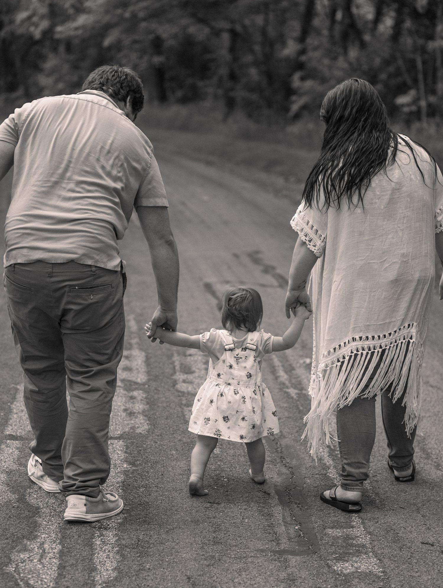 Low-angle black and white shot of people walking together on a path.