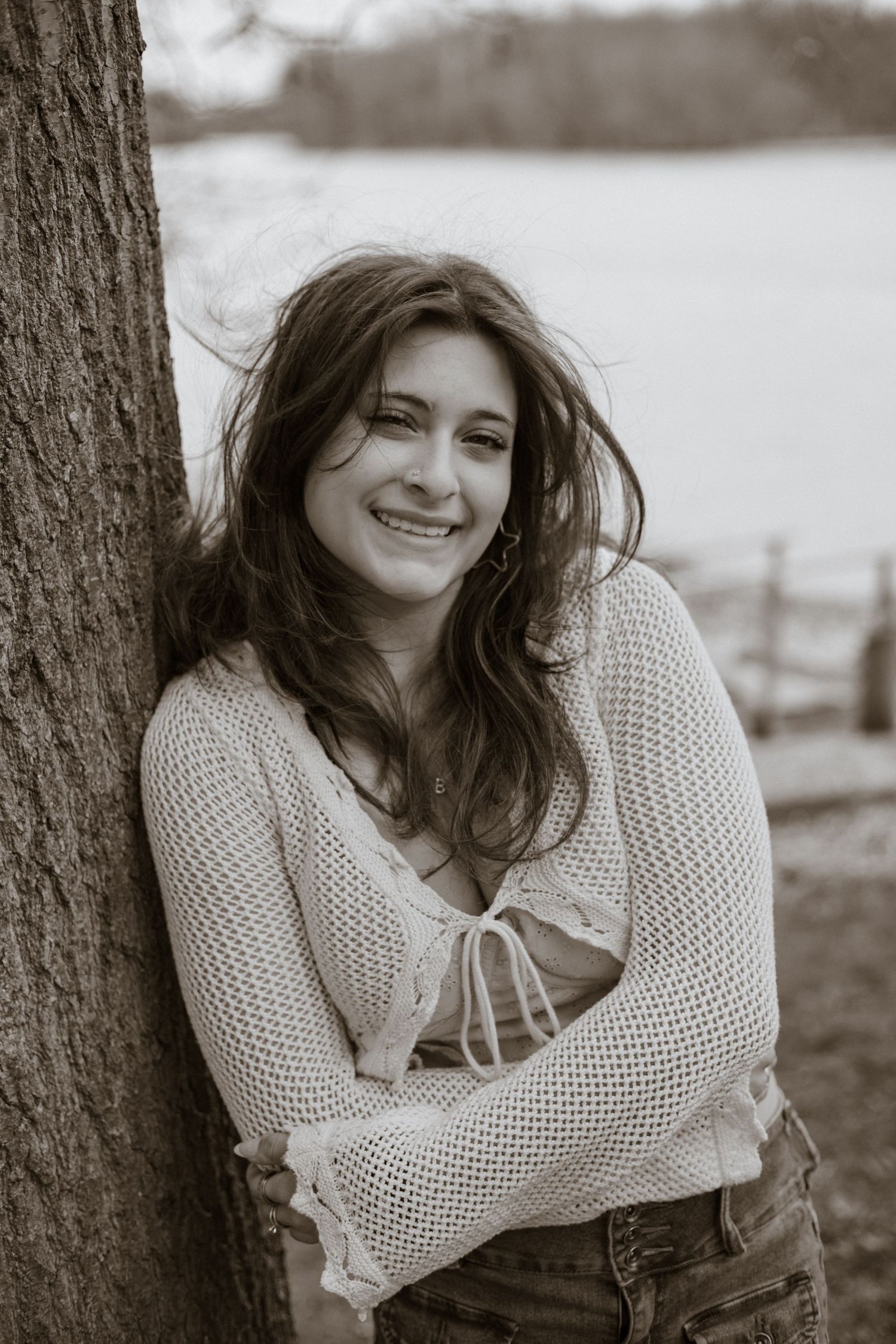 Black and white series showing candid expressions against natural outdoor backdrop.