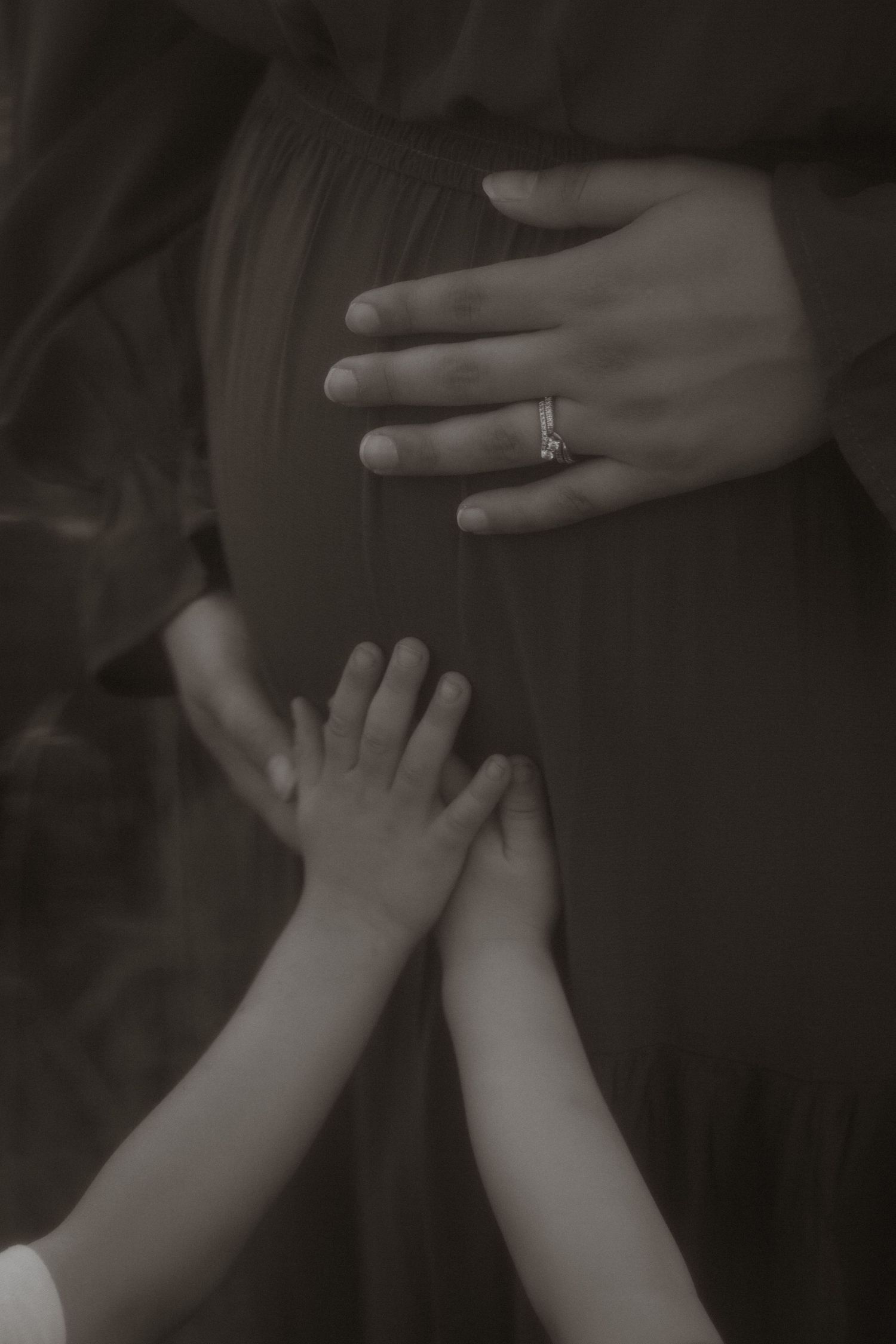 Black and white photo series showing hands with engagement ring in various poses.