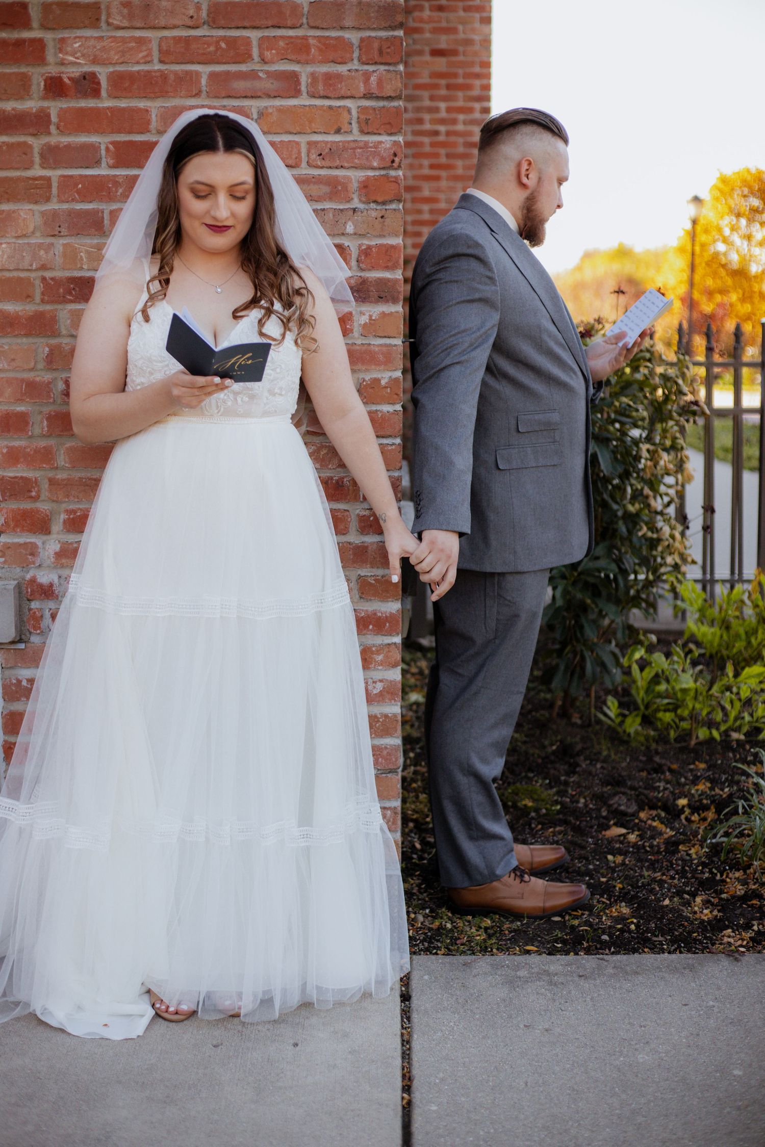Romantic first look sequence showing bride in white gown against brick wall backdrop.
