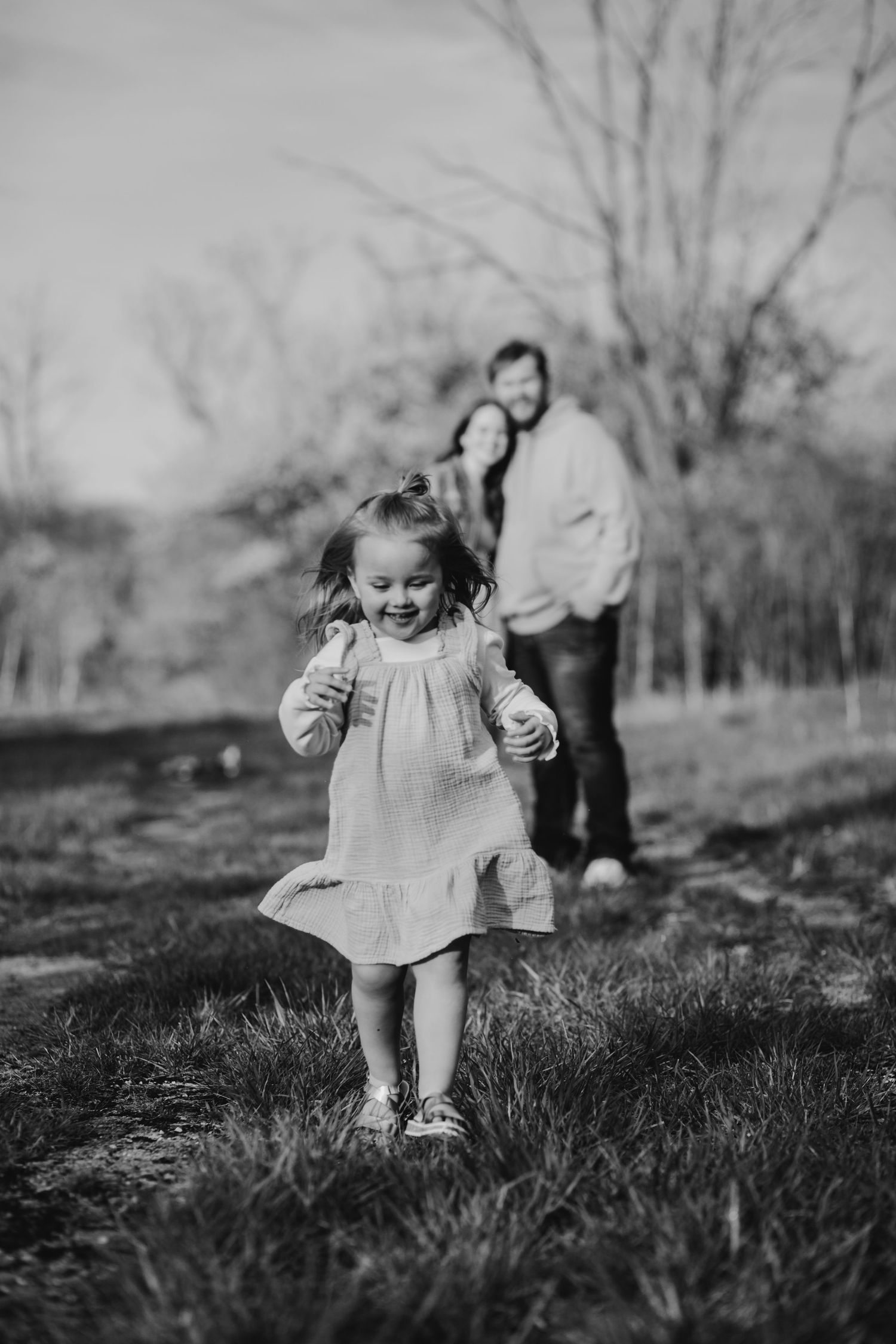Black and white photo capturing joyful outdoor moments in natural setting.