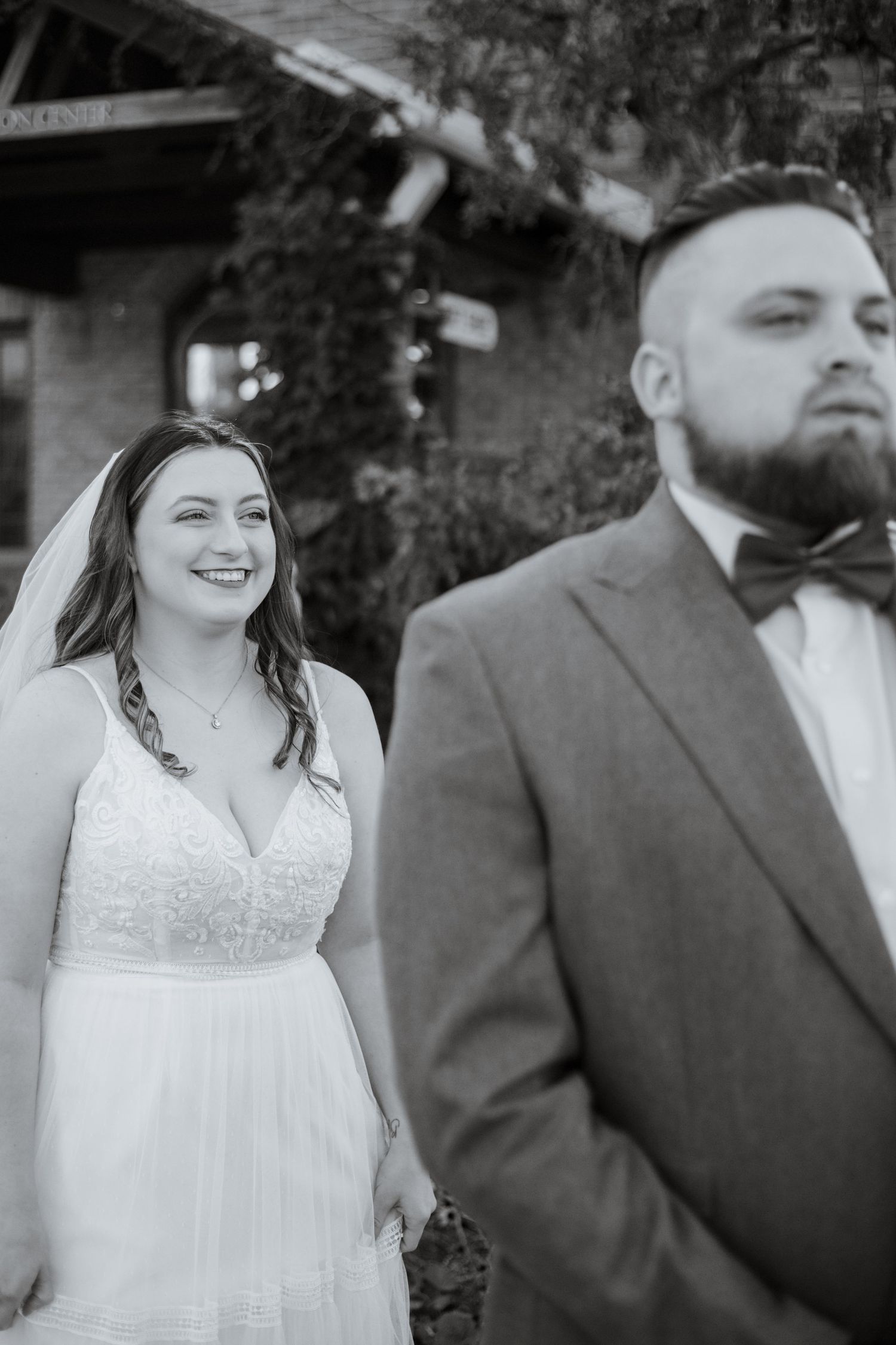 Black and white artistic wedding portraits against natural outdoor setting.