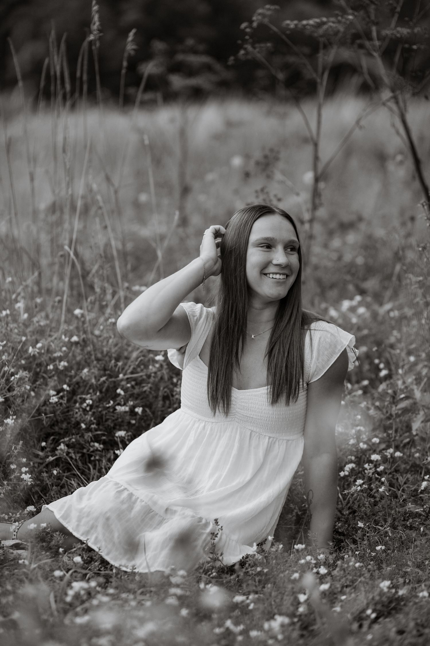 Black and white portrait in a wildflower meadow.
