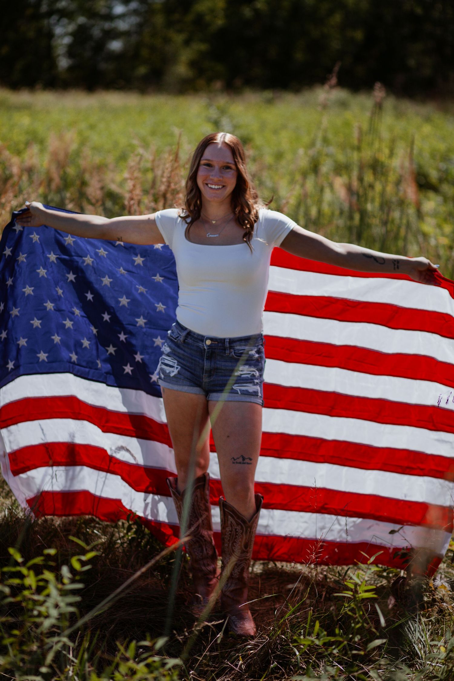 American flag displayed outdoors against natural grassy background.