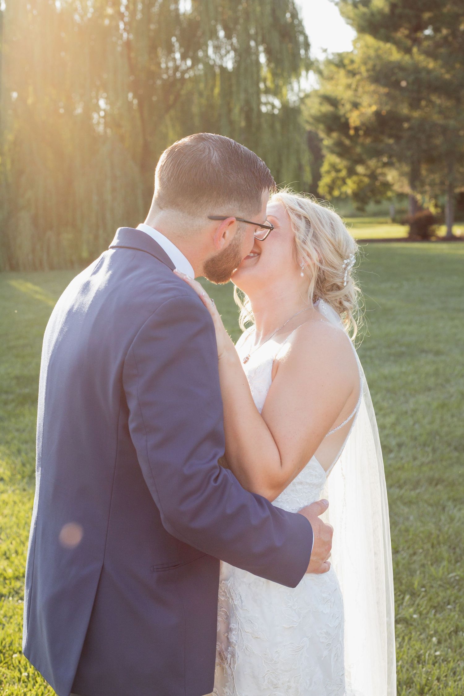 Sunlit wedding portraits capturing intimate moments in a garden setting.