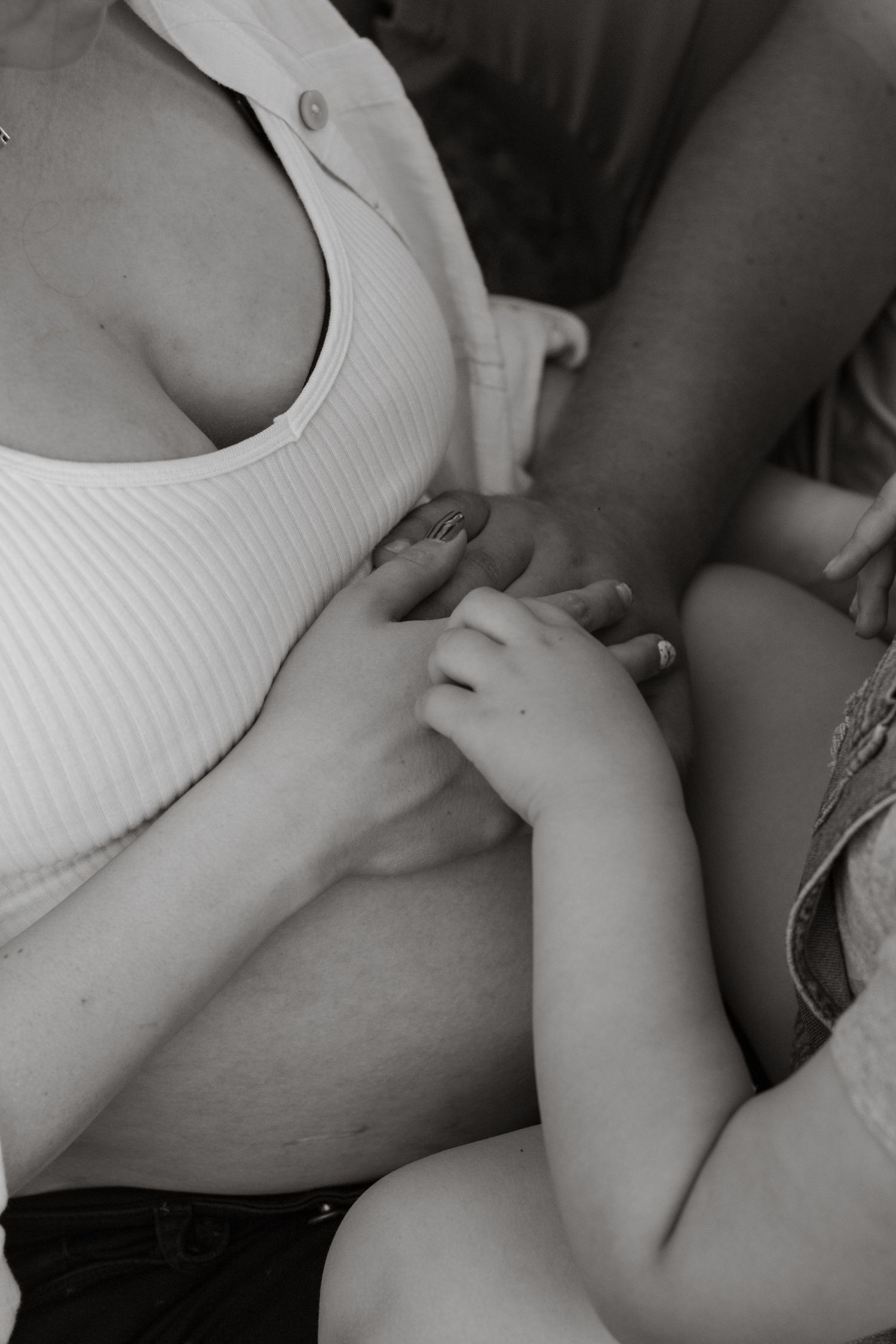 Close-up black and white images showing tender moments between parent and child.