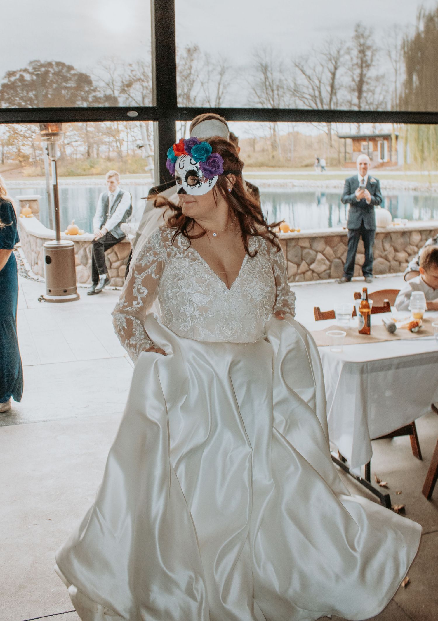 Flowing white wedding dress swirling during dance at outdoor reception.