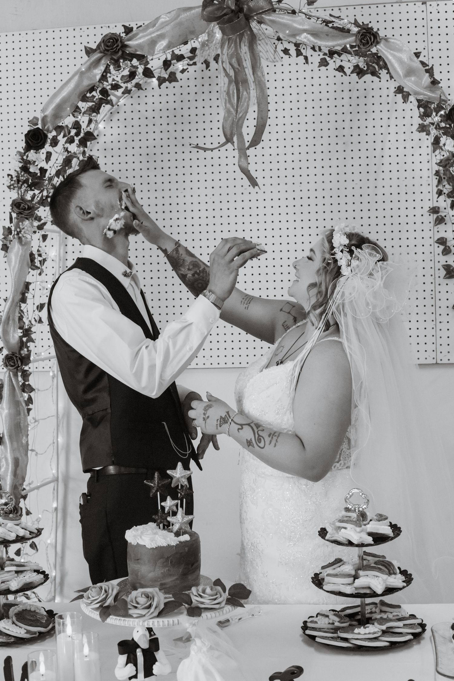 Black and white sequence of newlyweds feeding each other cake at their wedding reception.