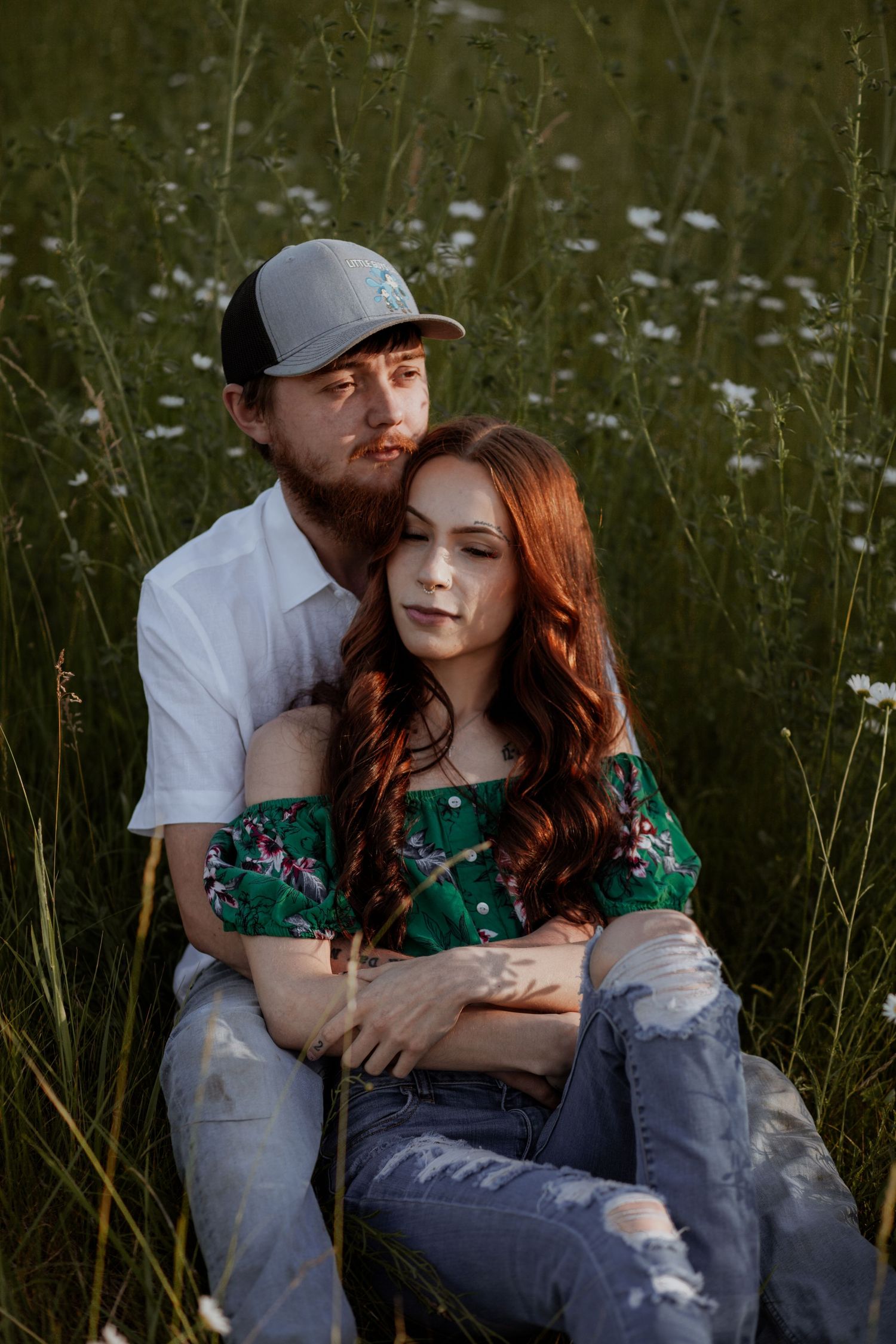 Intimate couple's portrait in a wildflower meadow during golden hour.