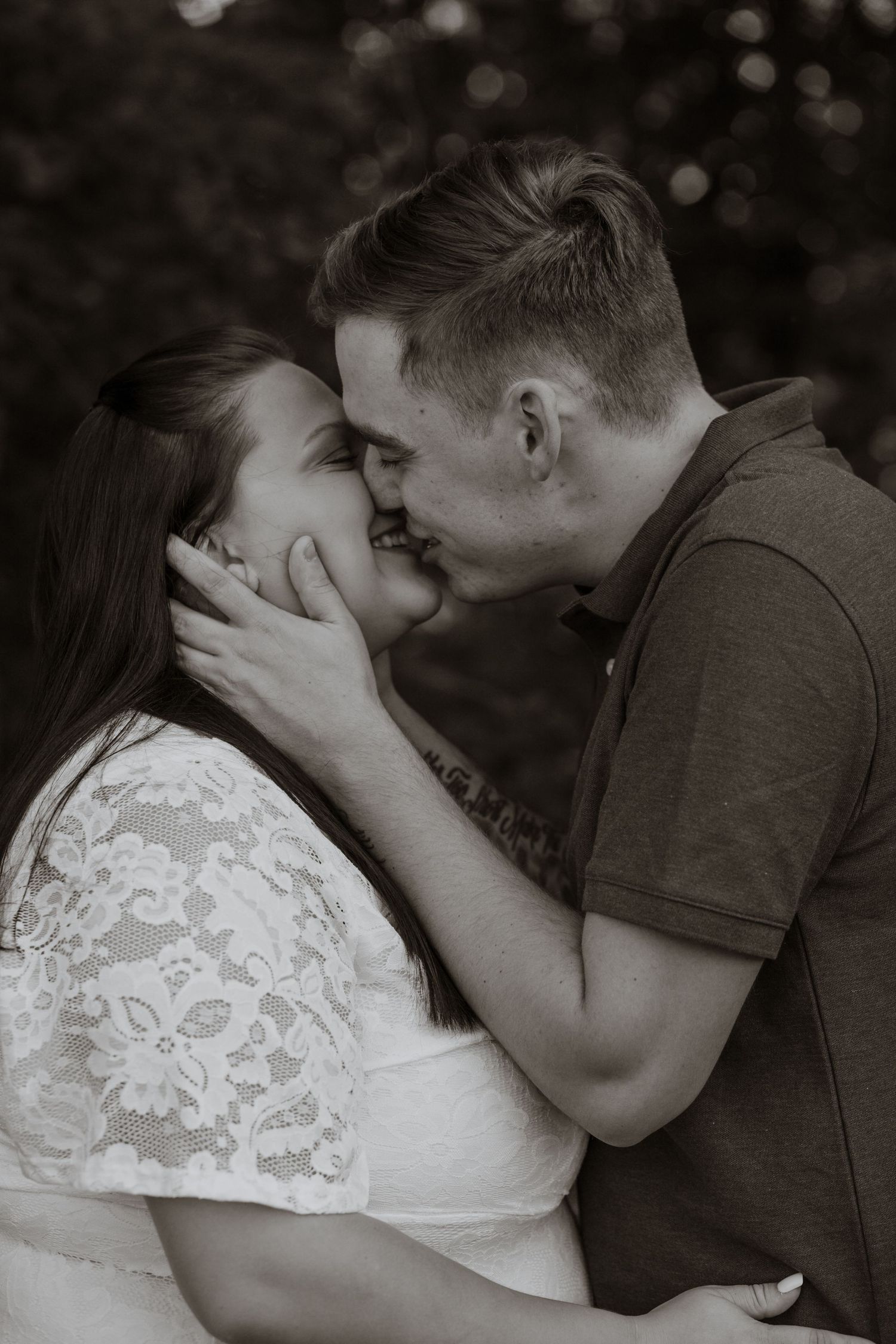 Intimate black and white portrait of couple sharing tender moment.