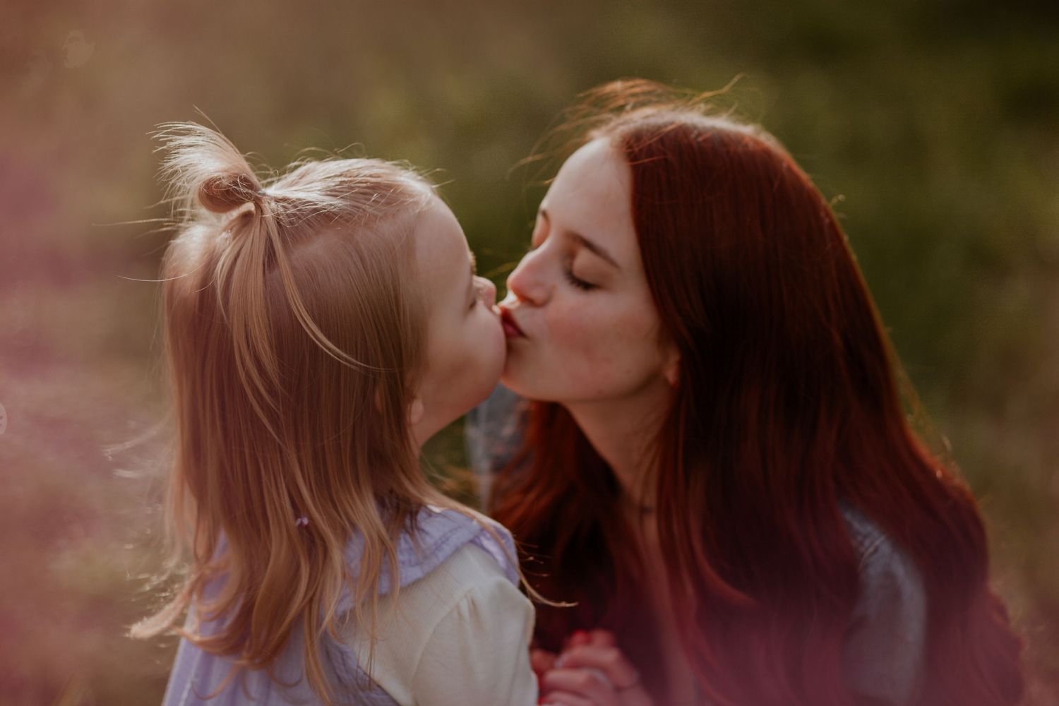 Sweet moments of affection captured in warm evening light outdoors.