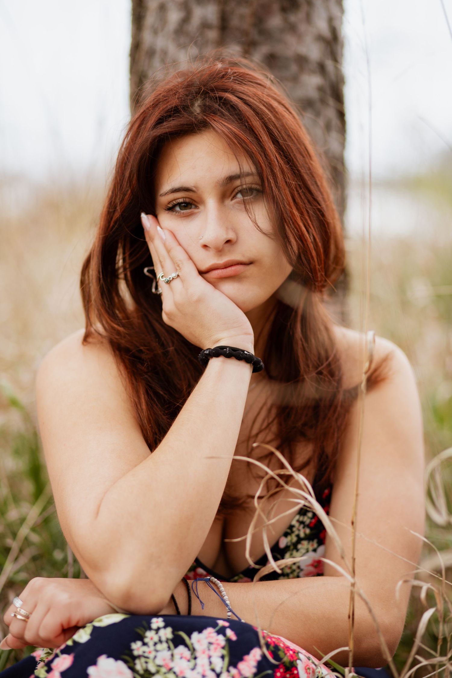Outdoor portrait in floral dress showing relaxed poses in natural setting.
