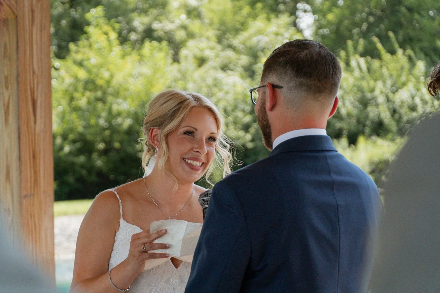 Candid wedding moment showing joyful exchange between couple during ceremony.