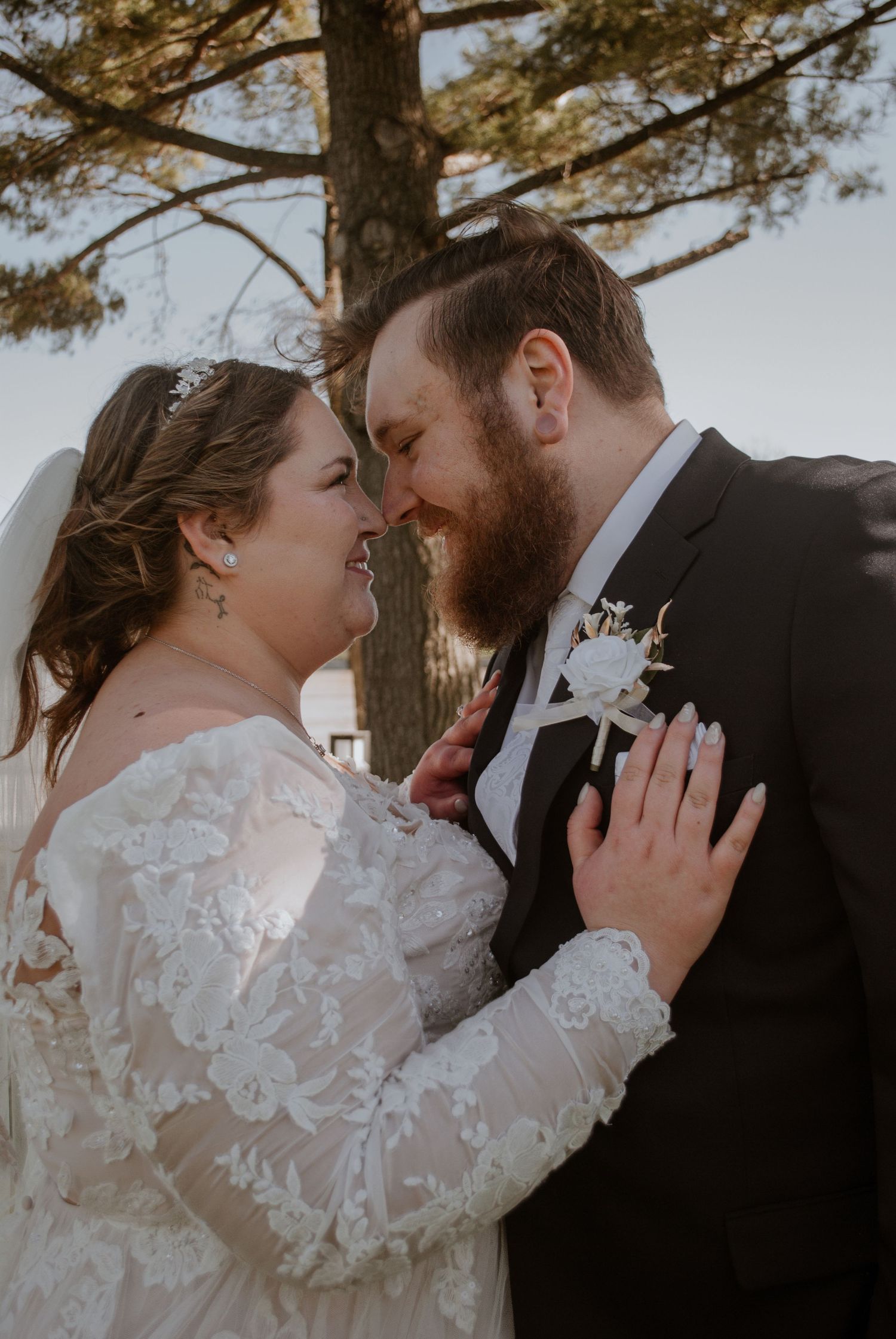 Intimate wedding portraits captured under pine trees at sunset.