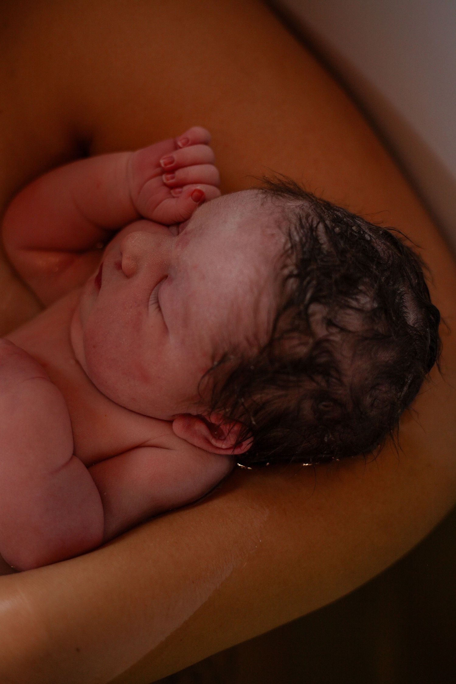 Series showing a newborn baby resting peacefully after delivery.
