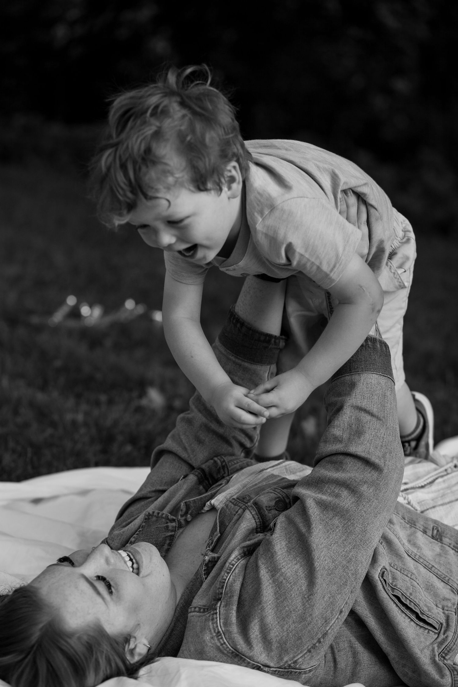 Black and white sequence of playful interaction between two people on the ground.