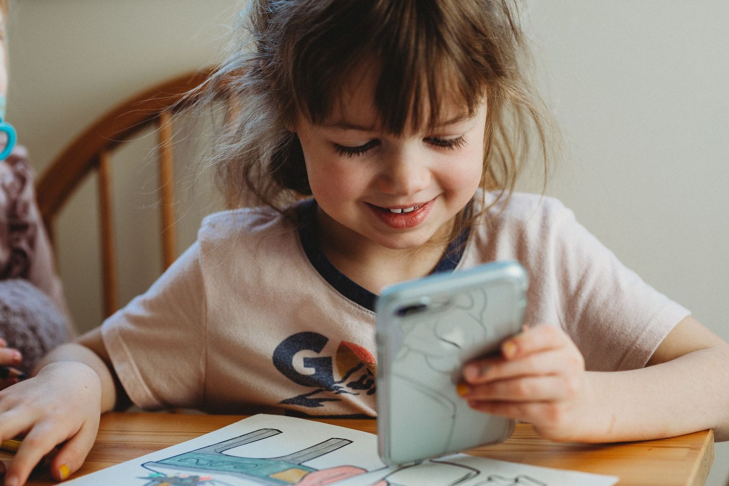 Girl on an iPhone in an in-home Calgary family photography session.