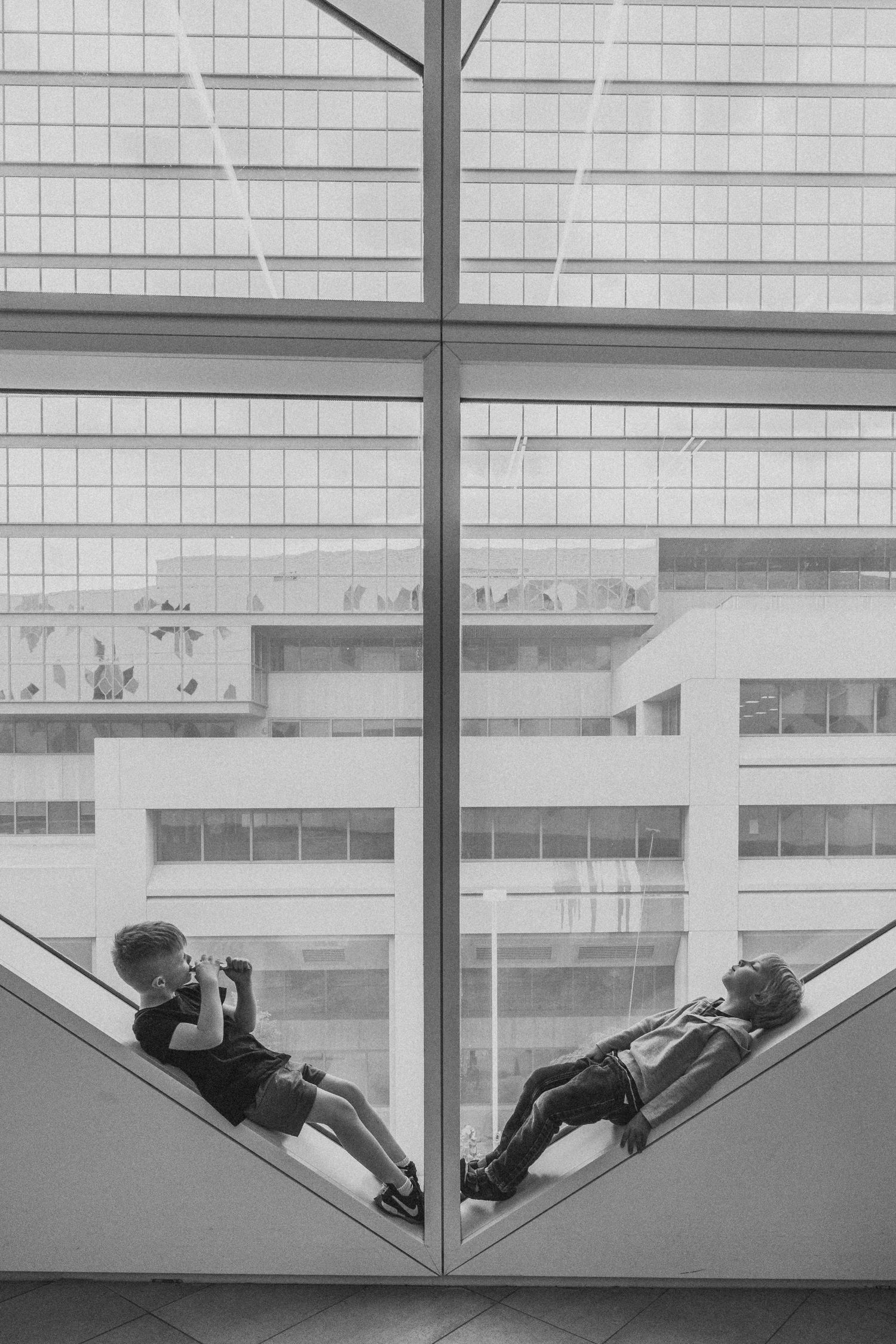 Boys in the window in a Calgary family photography session at the Central Calgary Public Library.