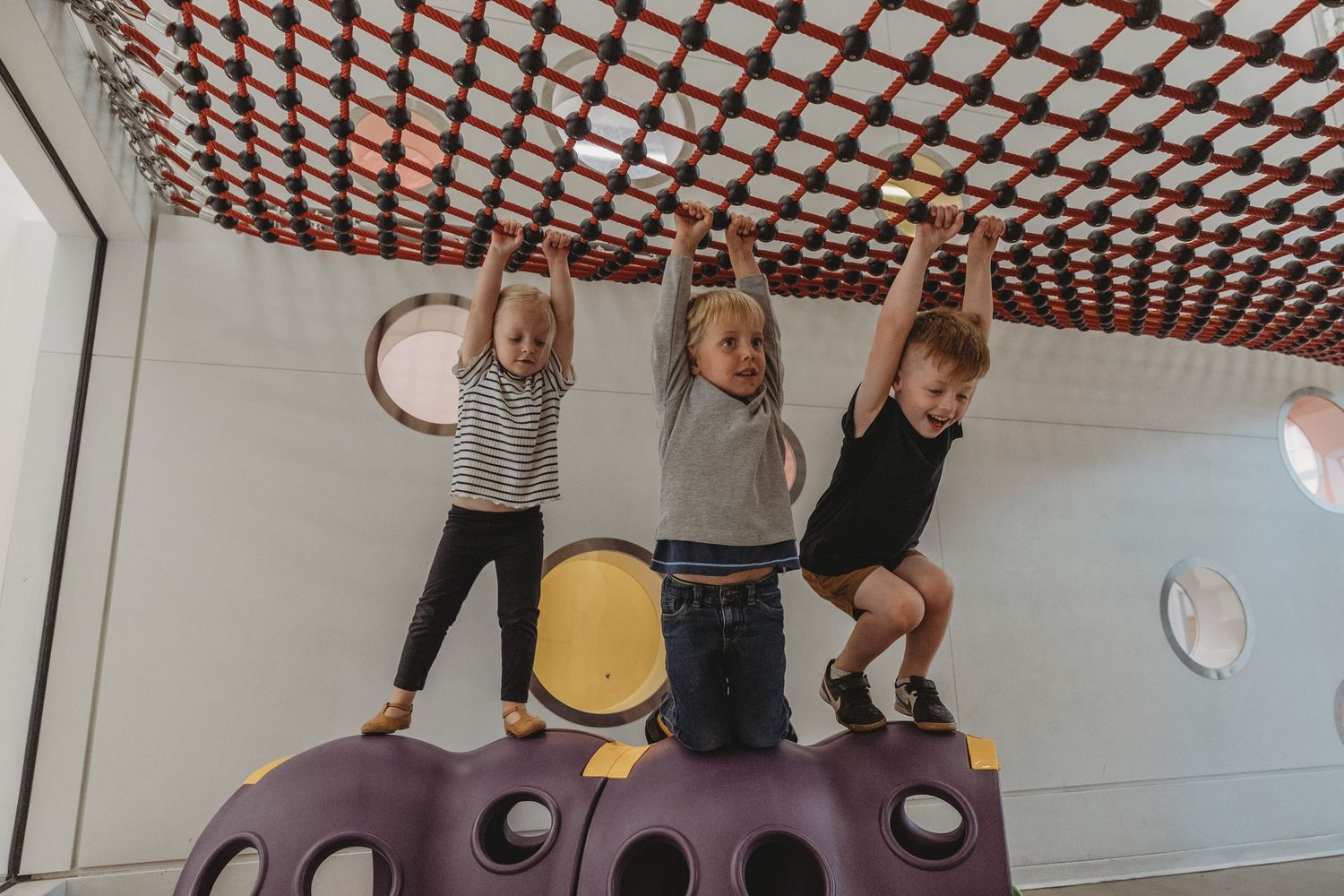 Kids on the play structure in a Calgary family photography session at the Central Calgary Public Library.