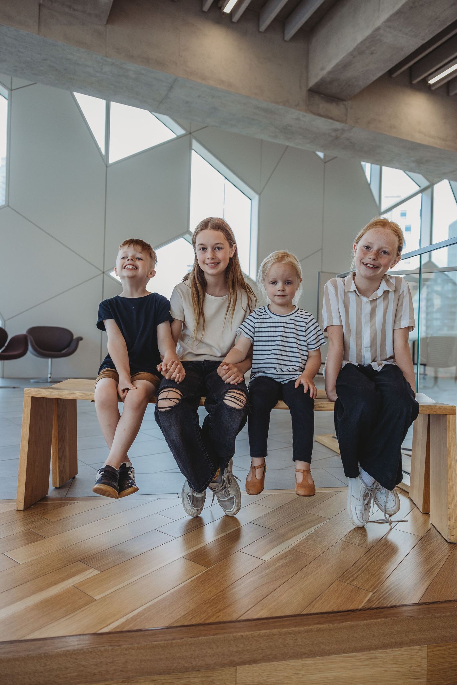 Family photo of siblings in a Calgary family photography session at the Central Calgary Public Library.