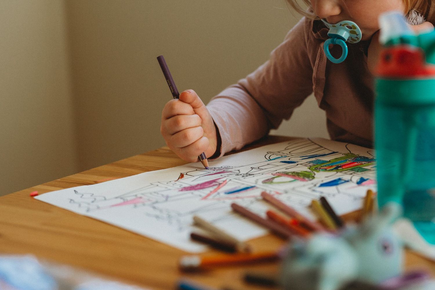 Girl colouring a picture in an in-home Calgary family photography session.