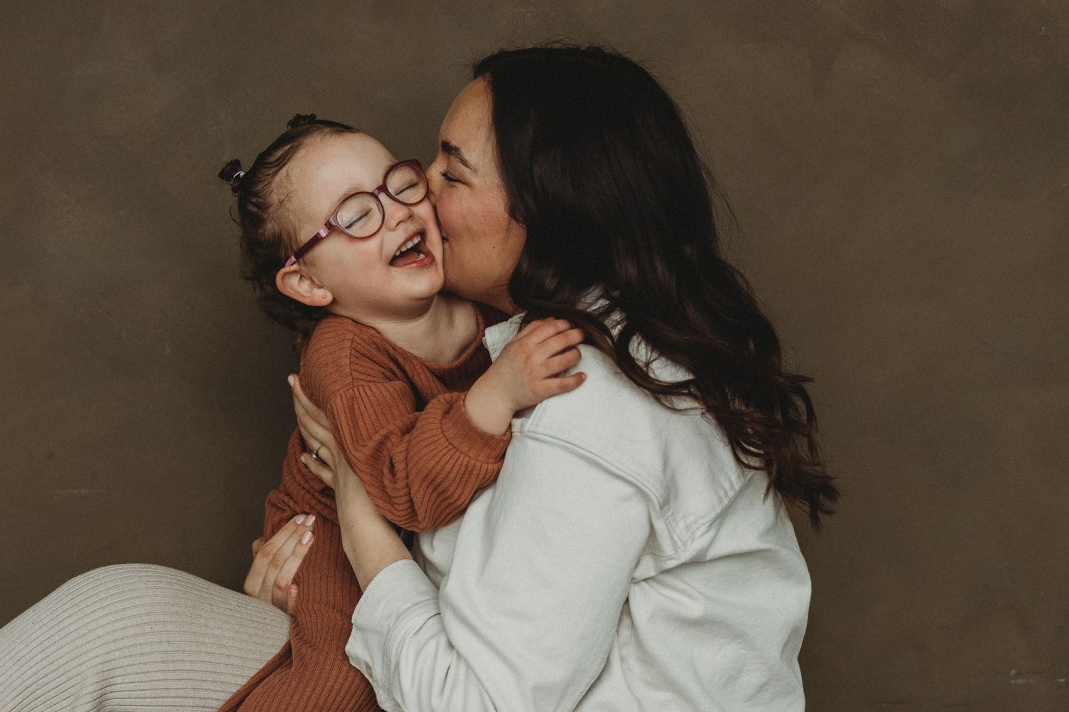 Mom with laughing toddler at Motherhood Mini Sessions at The Gallery Studio with Calgary family photographer