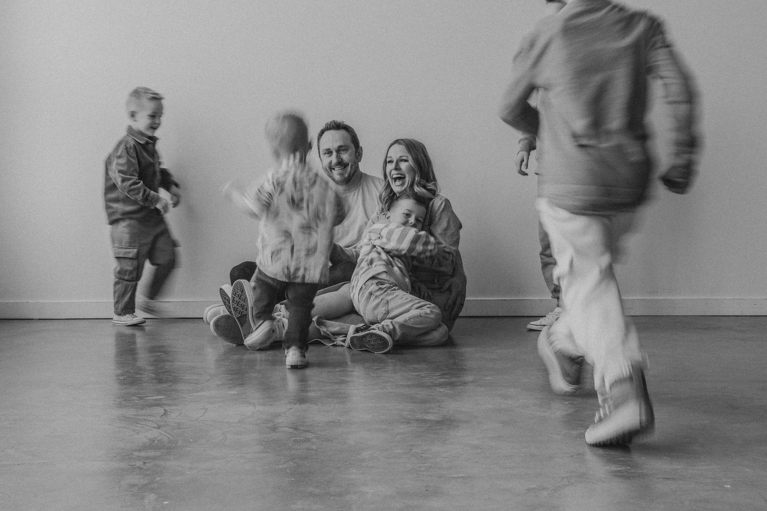 Family laughing together at Calgary Mini Sessions at The Gallery Studio with Calgary family photographer
