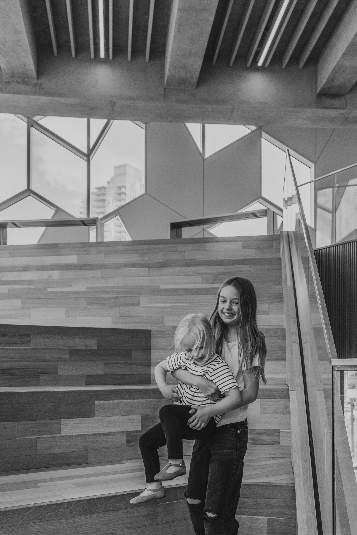 Sisters playing in a Calgary family photography session at the Central Calgary Public Library.