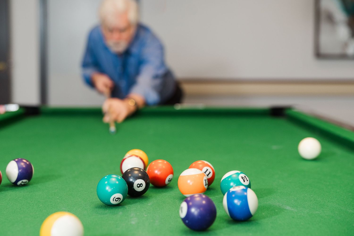 Beacon Hill senior living branding photo in Lombard, Illinois featuring resident playing pool