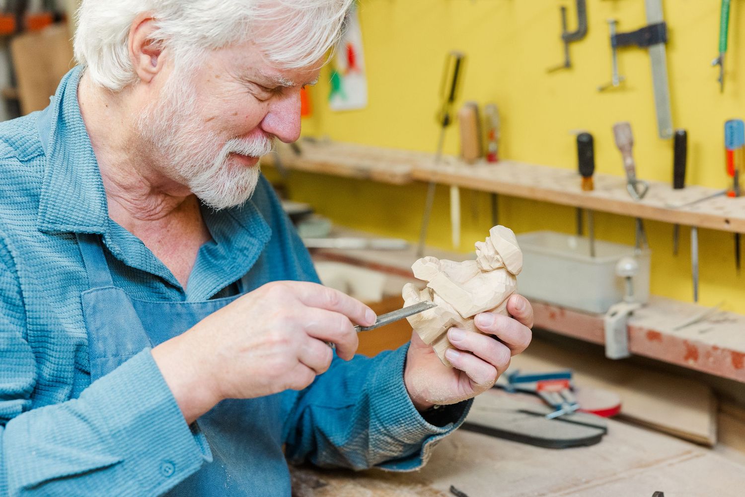 Beacon Hill senior living branding photo in Lombard, Illinois featuring resident woodworking with hand tools
