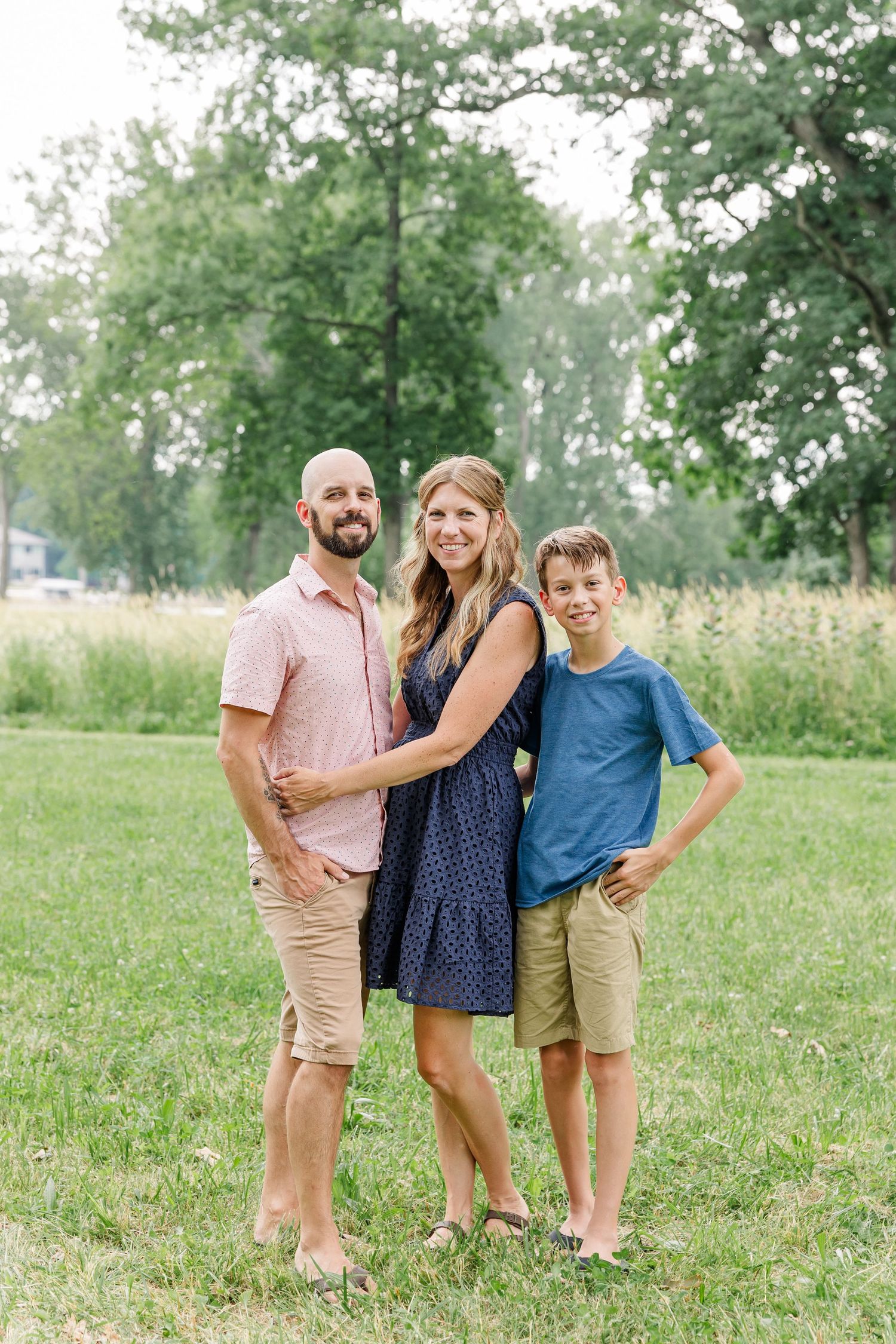 Family of four standing together outdoors during a summer family portrait session in Crystal Lake, Illinois.
