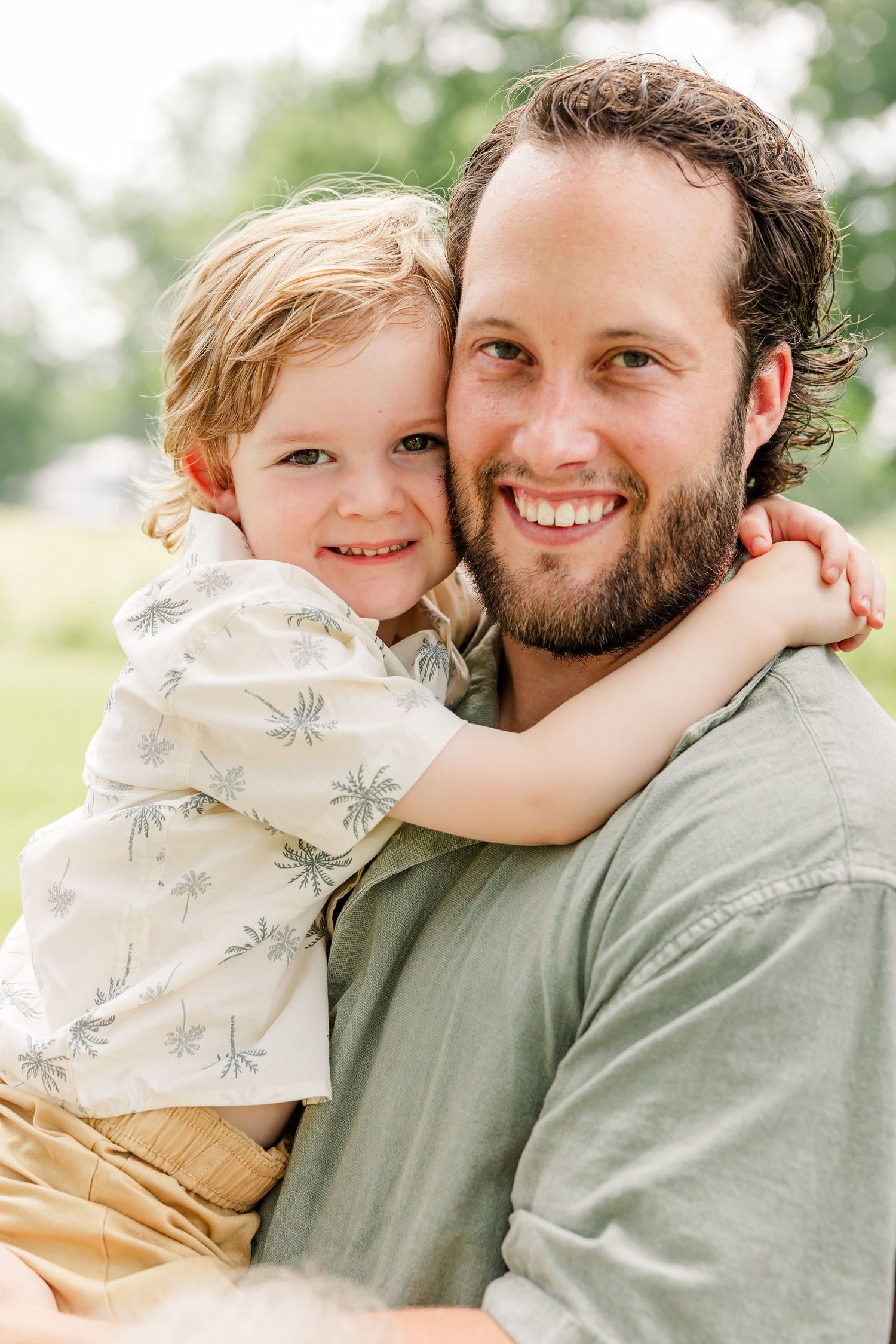 Dad holding his young son for a sweet summer portrait during a Crystal Lake family session.