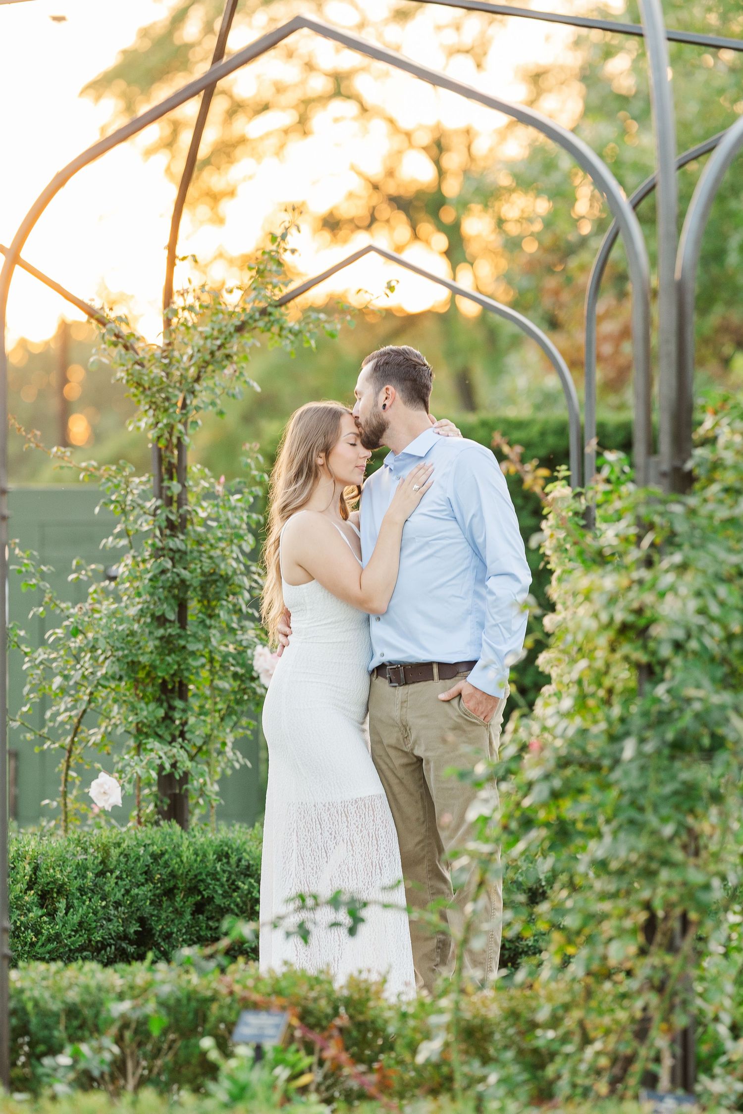 Couple embracing at sunset during engagement photos at Cantigny Park in Wheaton, Illinois