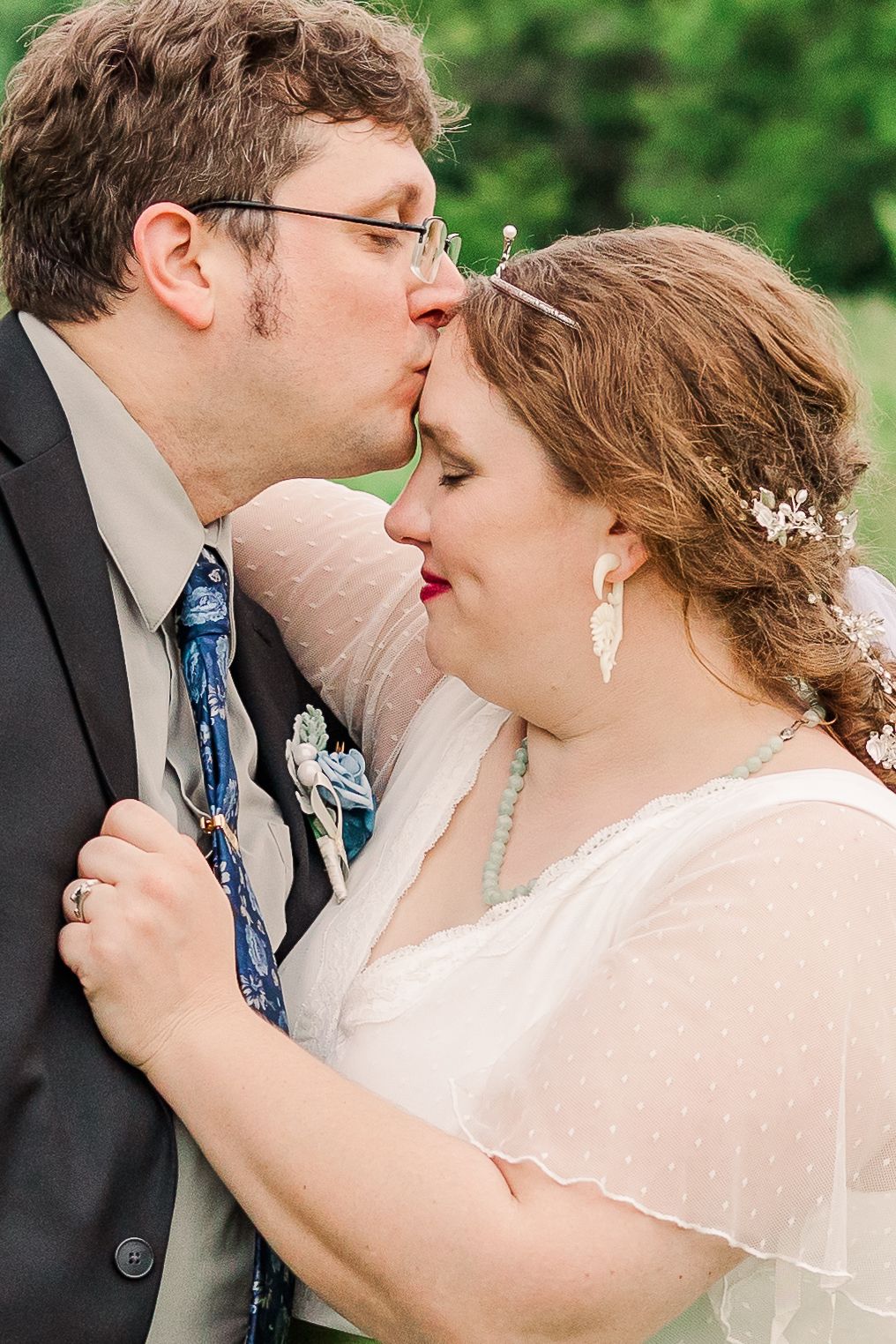 An intimate wedding portrait capturing a tender moment between the newlyweds.