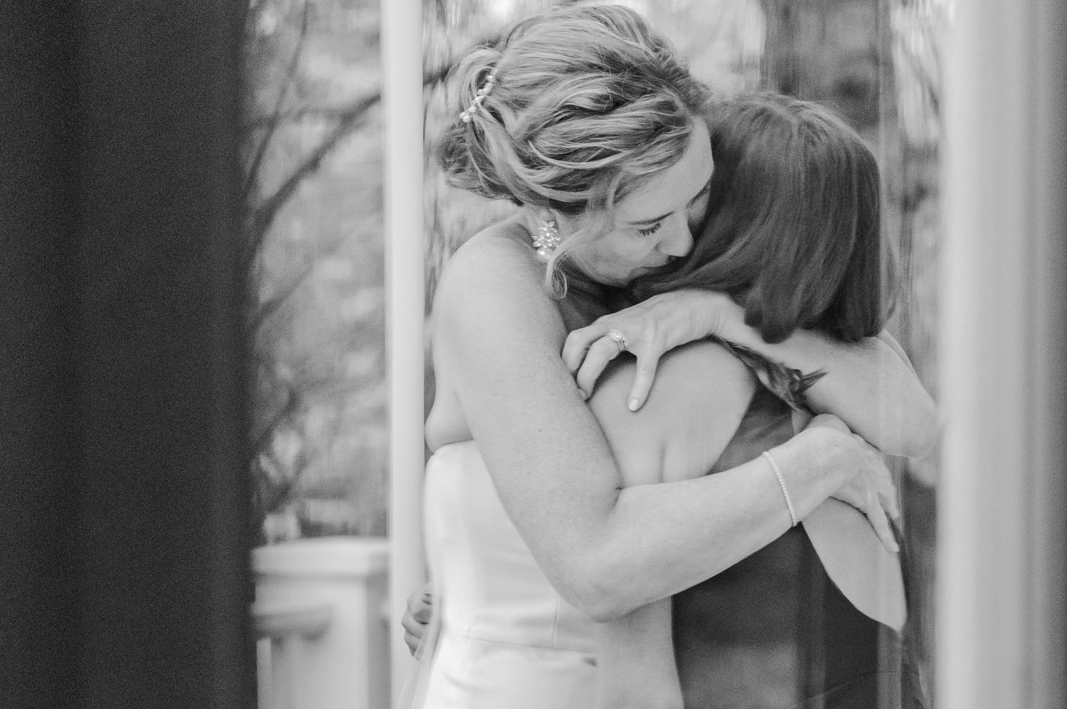 Black and white emotional moment captured during formal celebration.