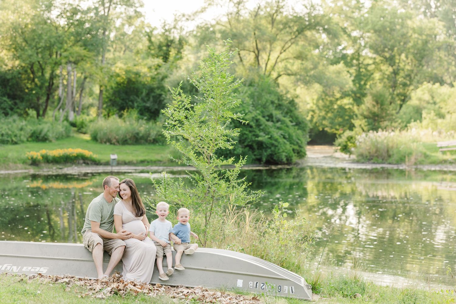 A rustic outdoor wedding ceremony in a picturesque garden setting with lush greenery and a tranquil pond.