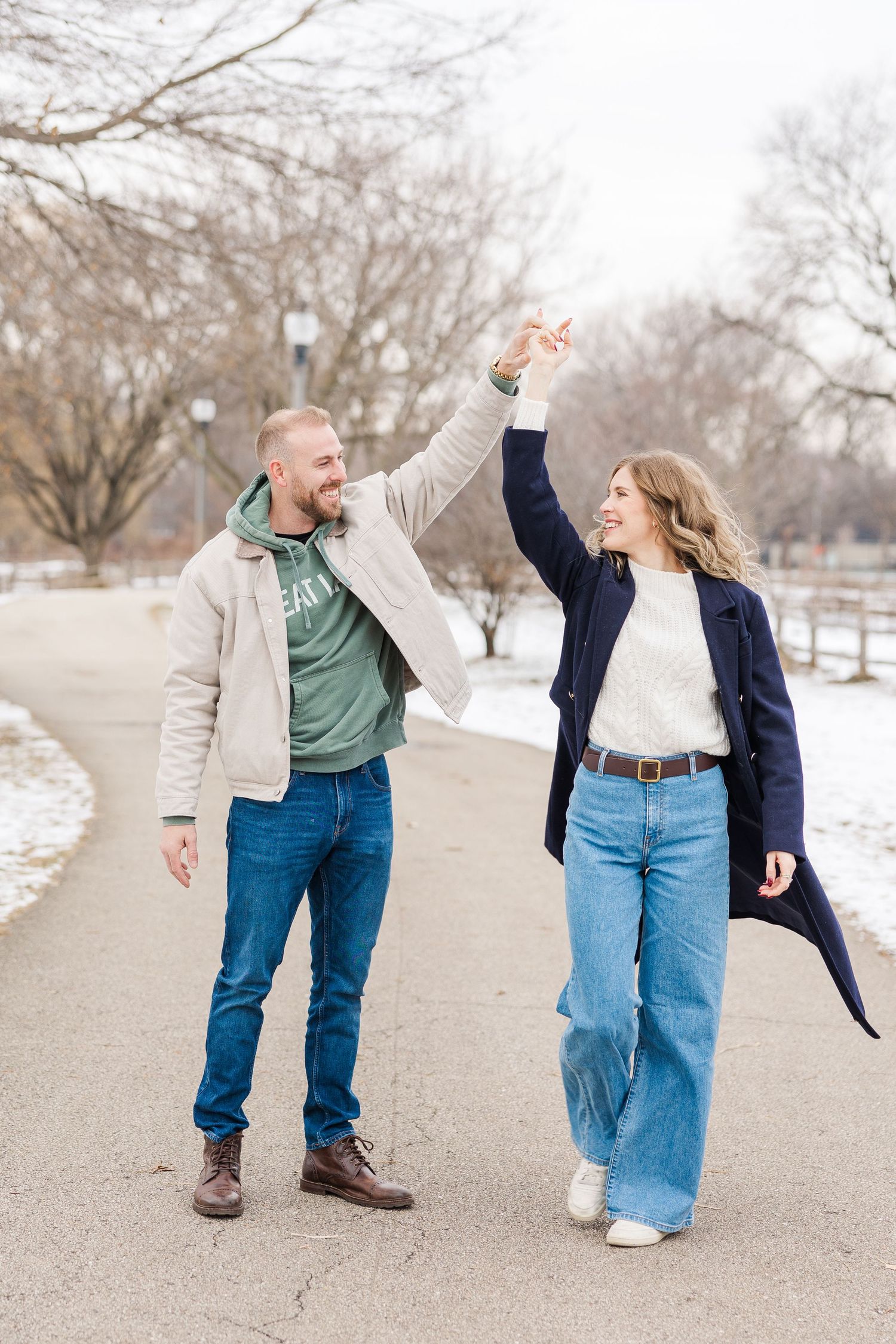 Couple twirls after getting engaged in Winnemac Park Chicago