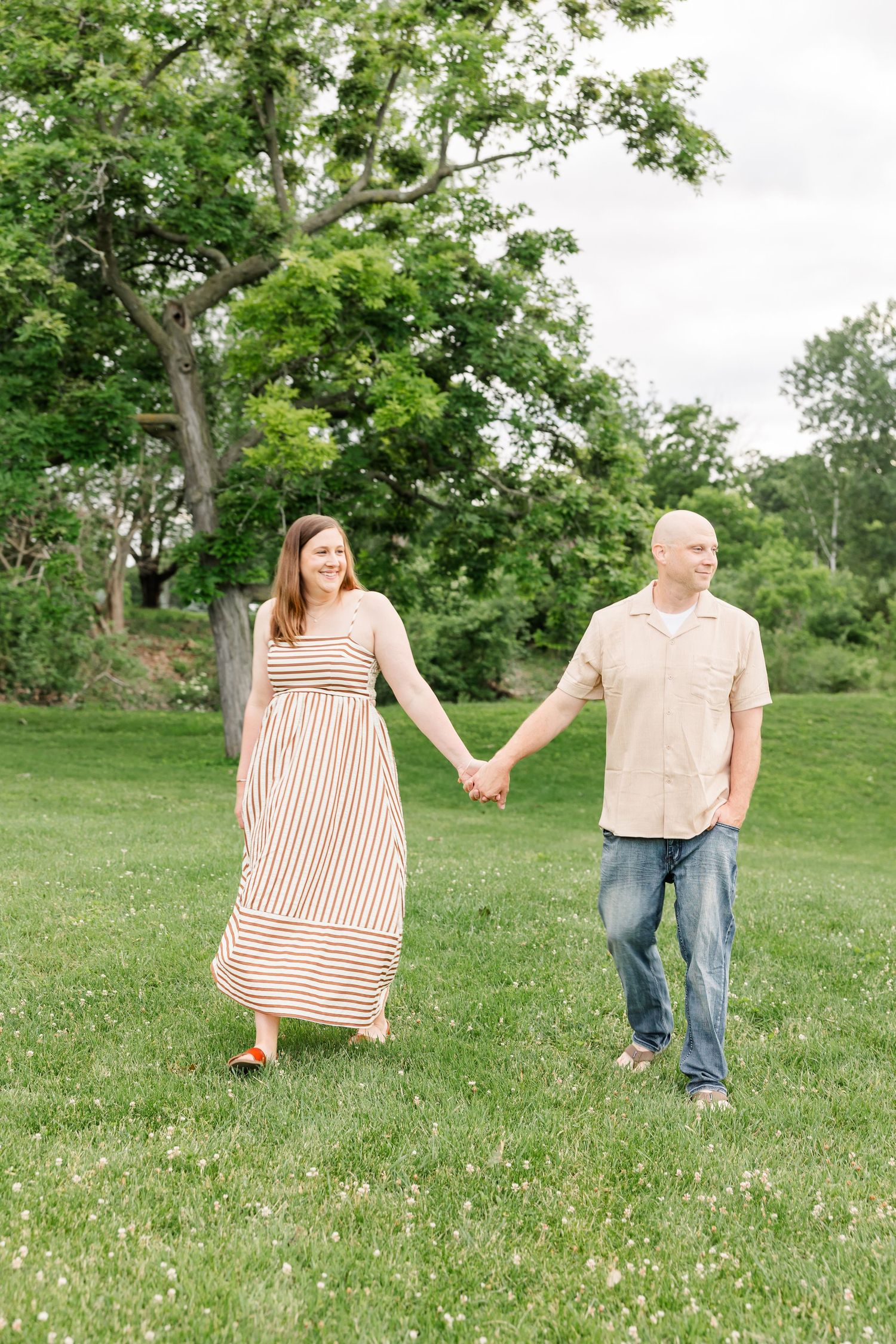 Mom and dad walking together during a summer family portrait session at Shamrock Hills Park.
