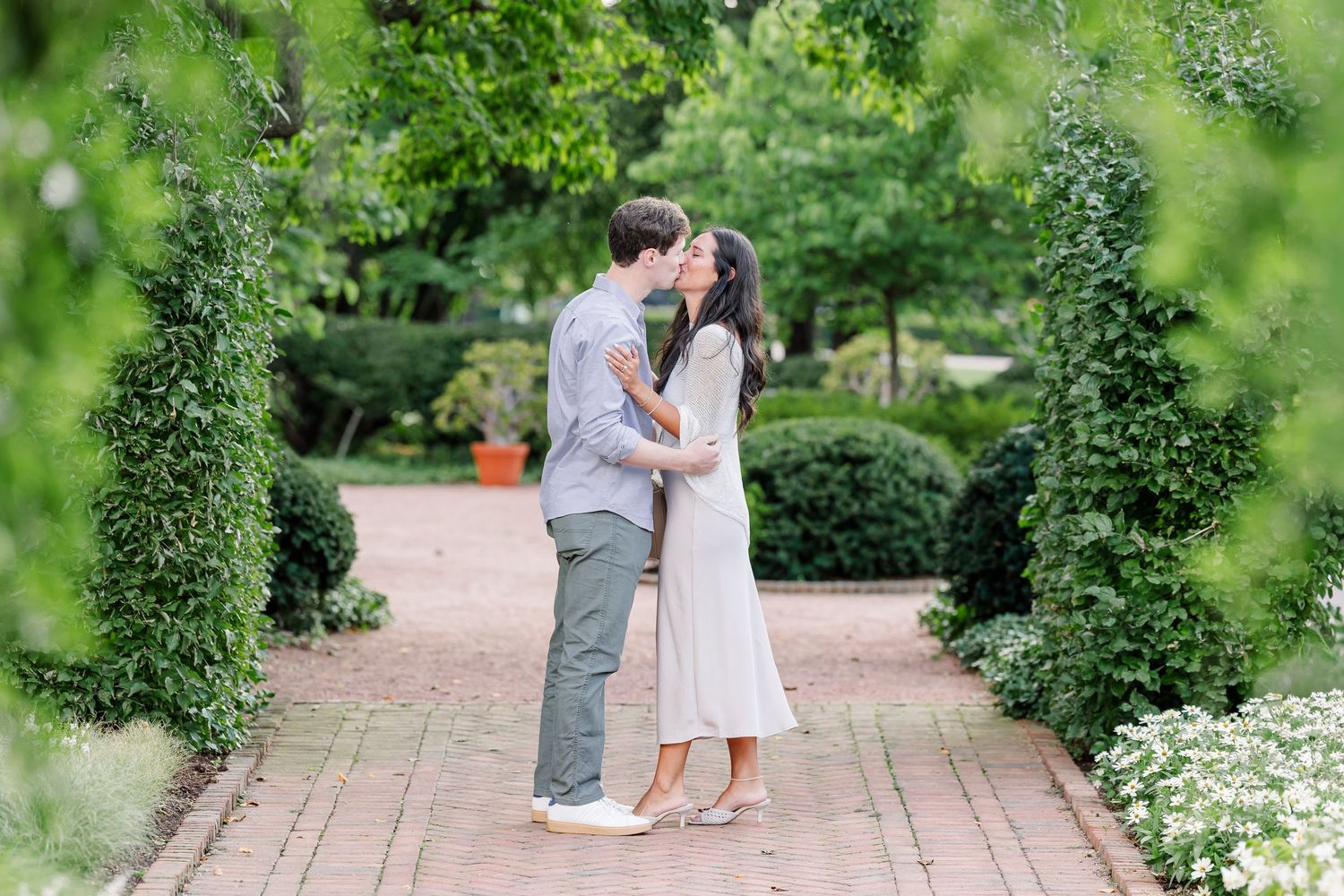 Alysia and Jack share their first kiss as an engaged couple in the garden.