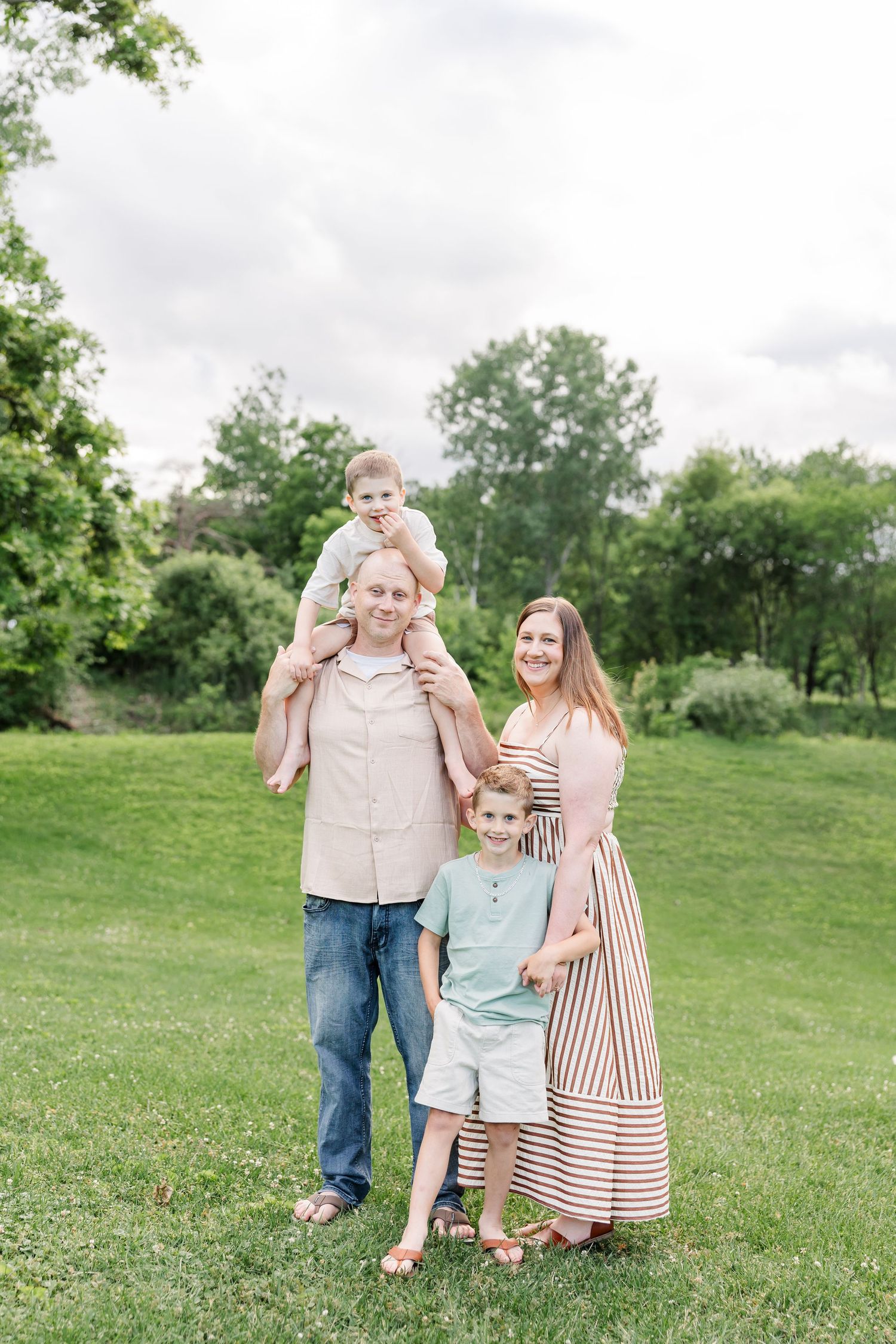 Dad holding his son on his shoulders during a playful family portrait session in Crystal Lake, Illinois.