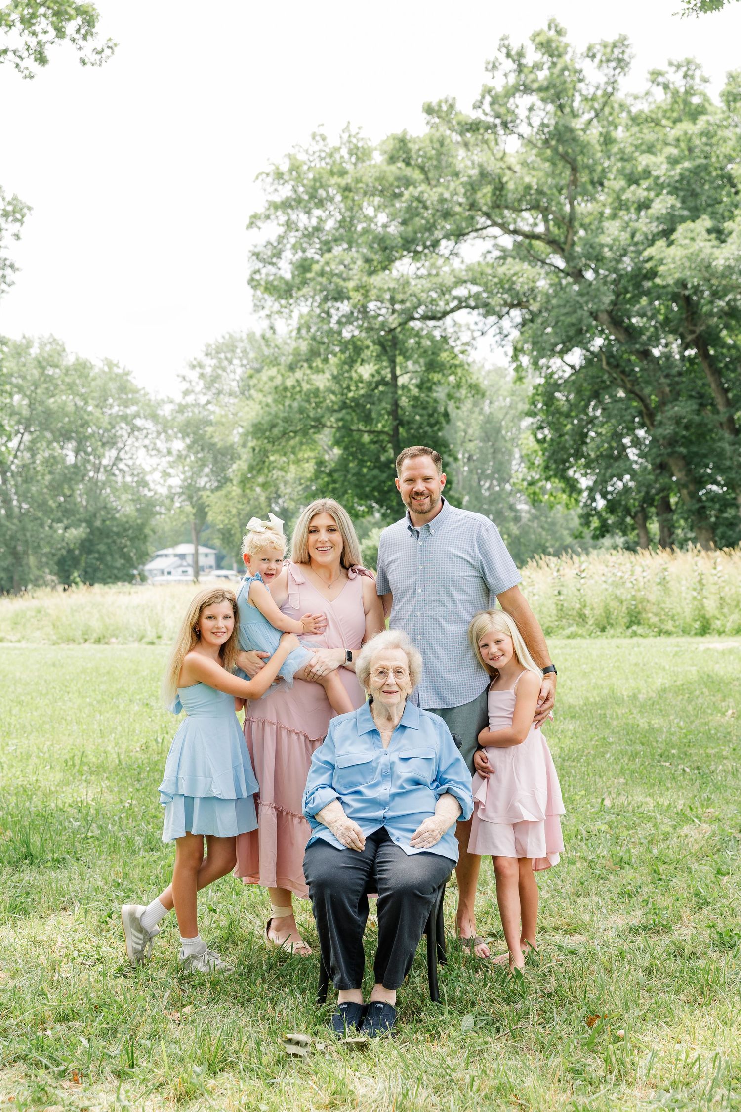 Grandparents smiling with their grandchildren during a summer family reunion photo session in Crystal Lake, IL.
