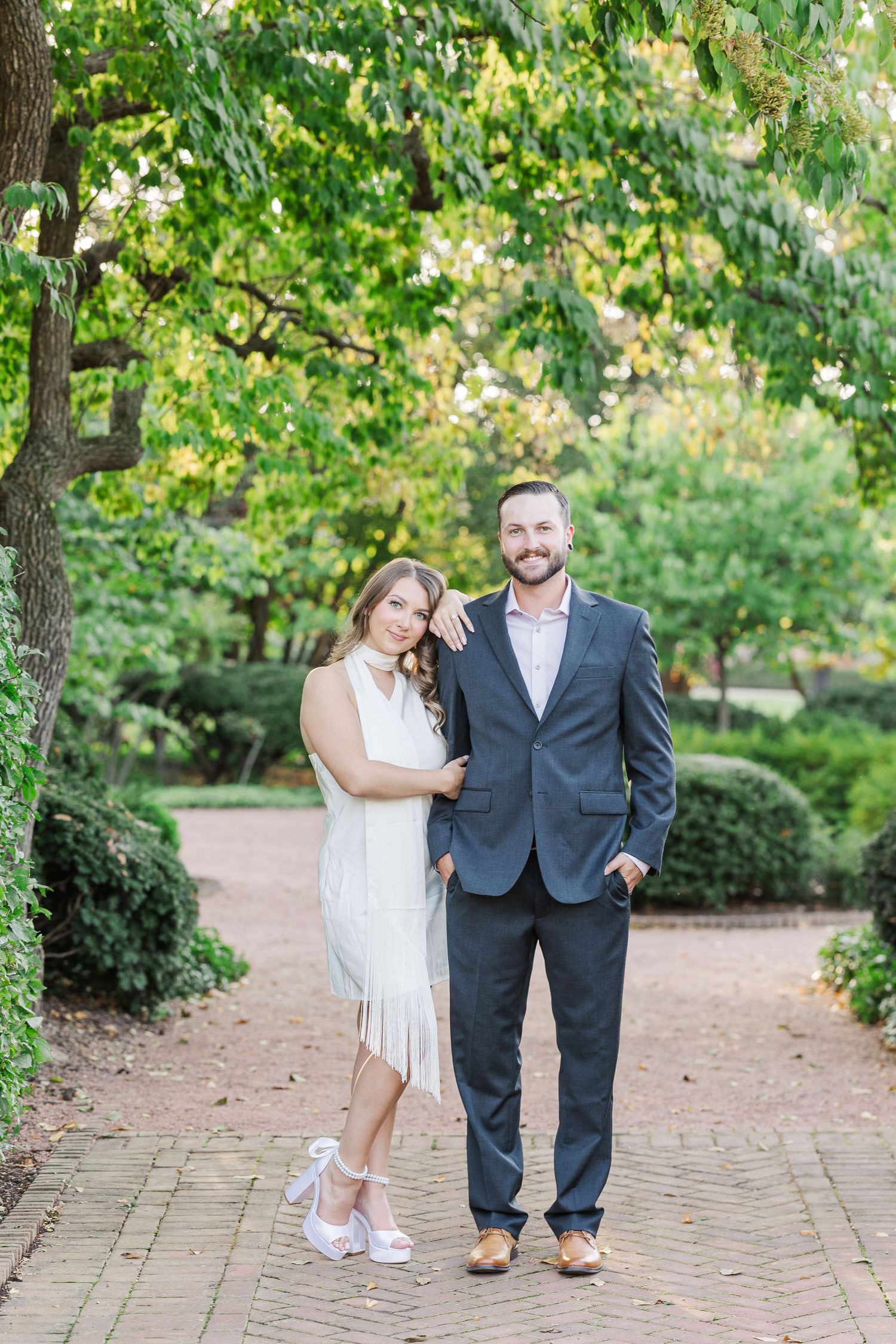 Couple posing together in garden during engagement photos at Cantigny Park in Wheaton, Illinois