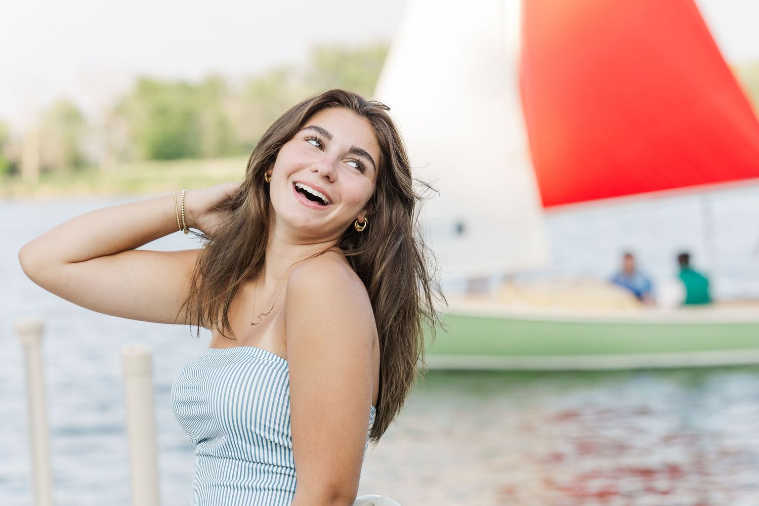 Teen girl portrait with sailboat during Pistakee Lake family photos in Johnsburg, Illinois