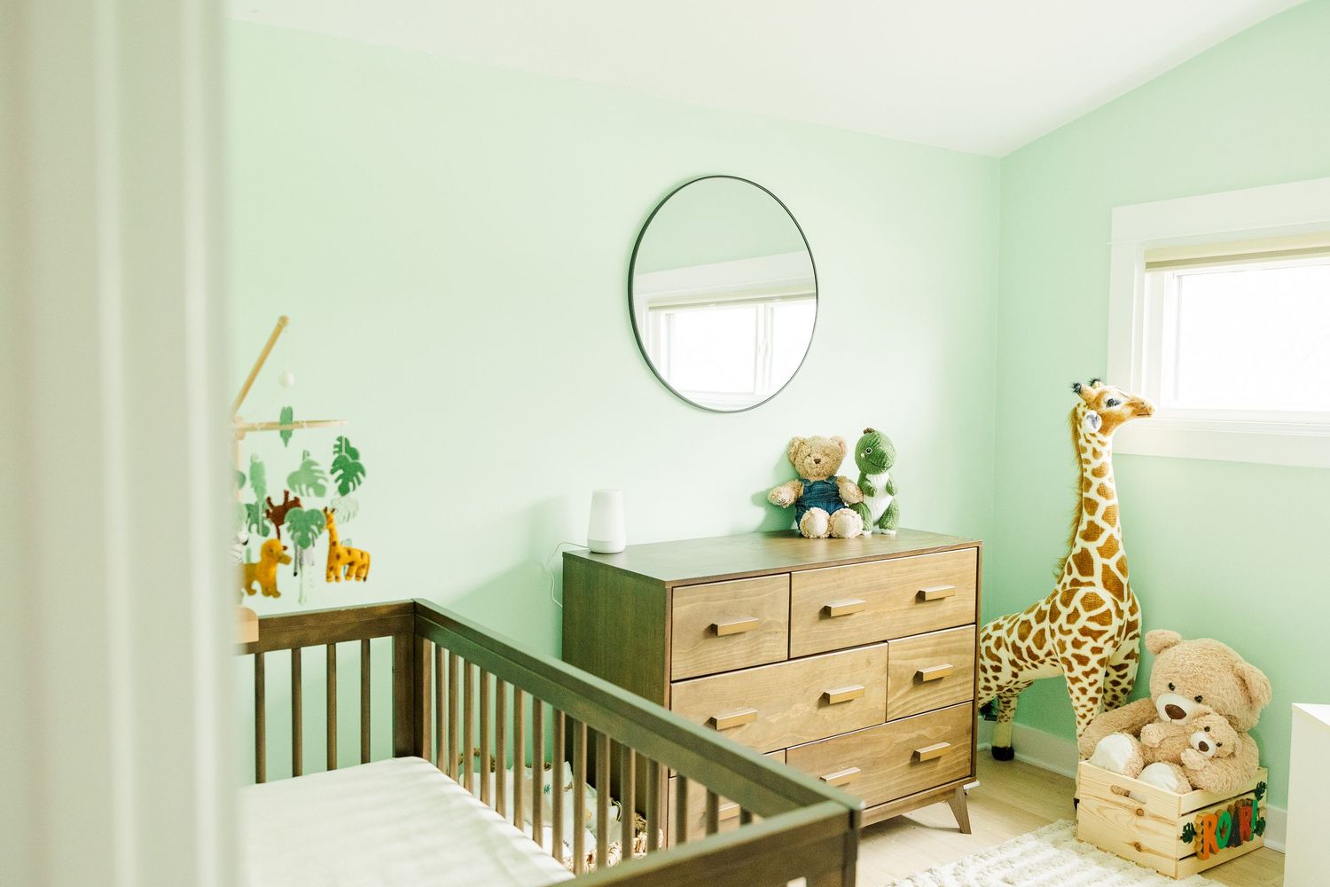 Modern baby nursery with crib and giraffe decor photographed during an in-home newborn session in Palatine Illinois
