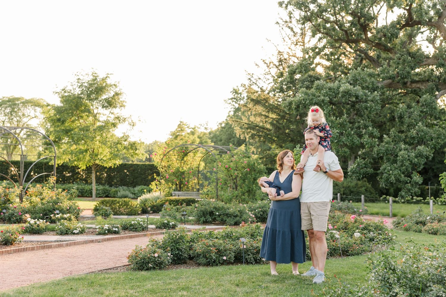 The Lawler family standing together among the colorful summer gardens at Cantigny Park.