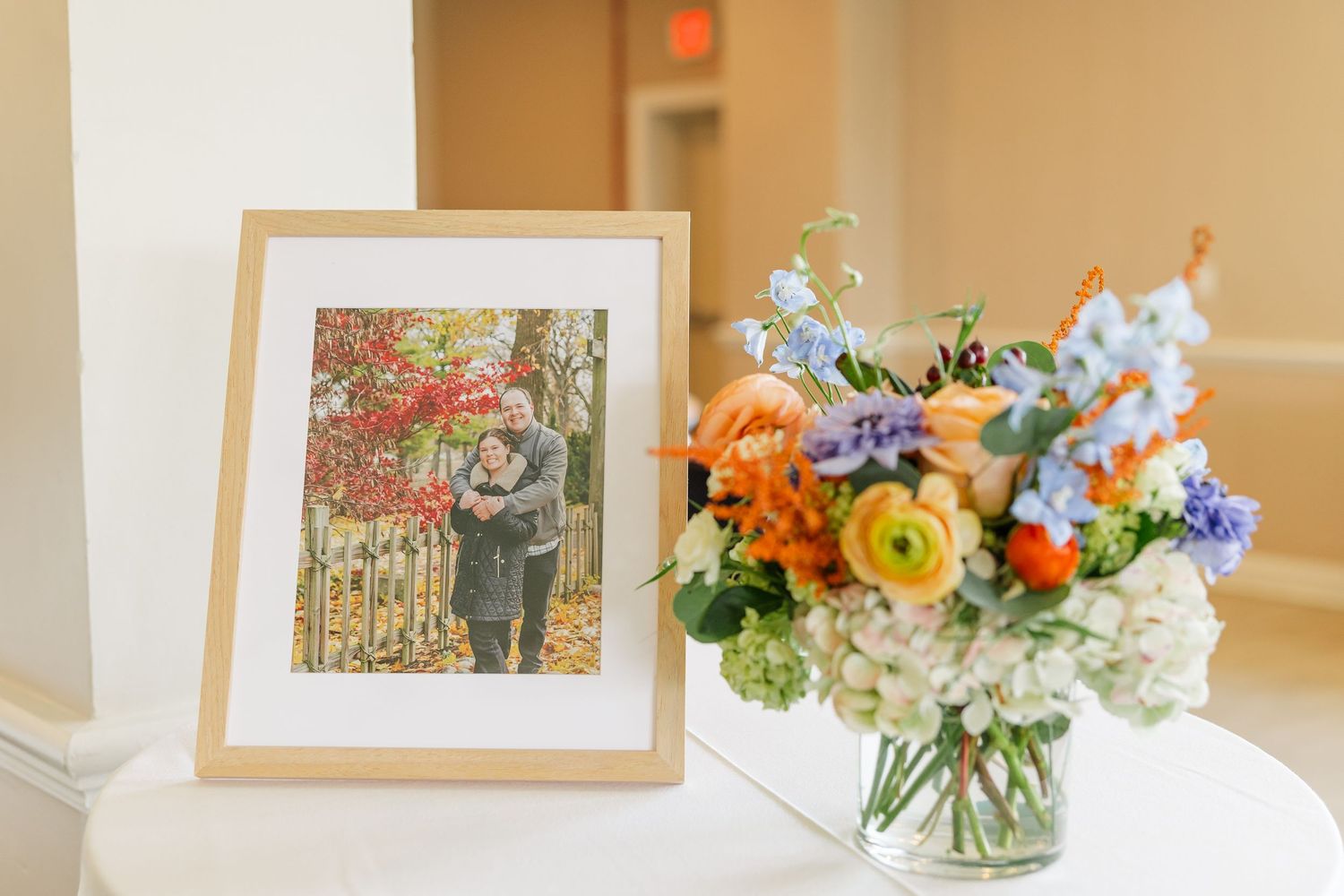 Framed artwork paired with fresh wildflower arrangement at bridal shower
